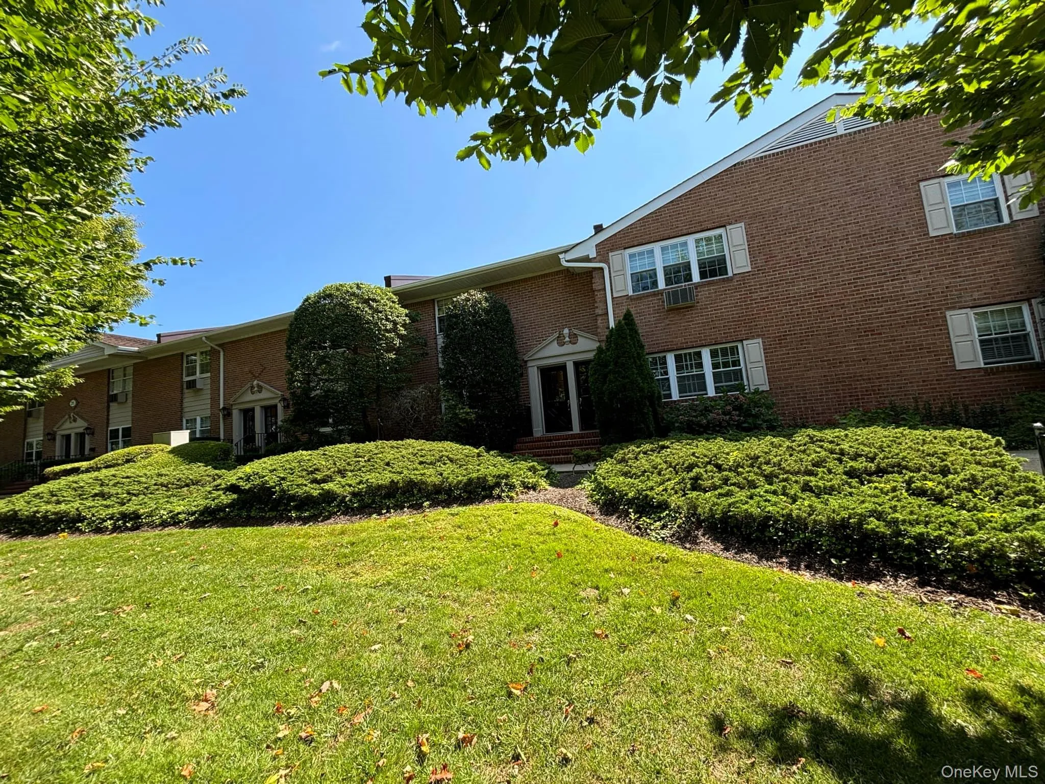 View of front of home with brick siding and a front yard View of front of home with brick siding and a front yard