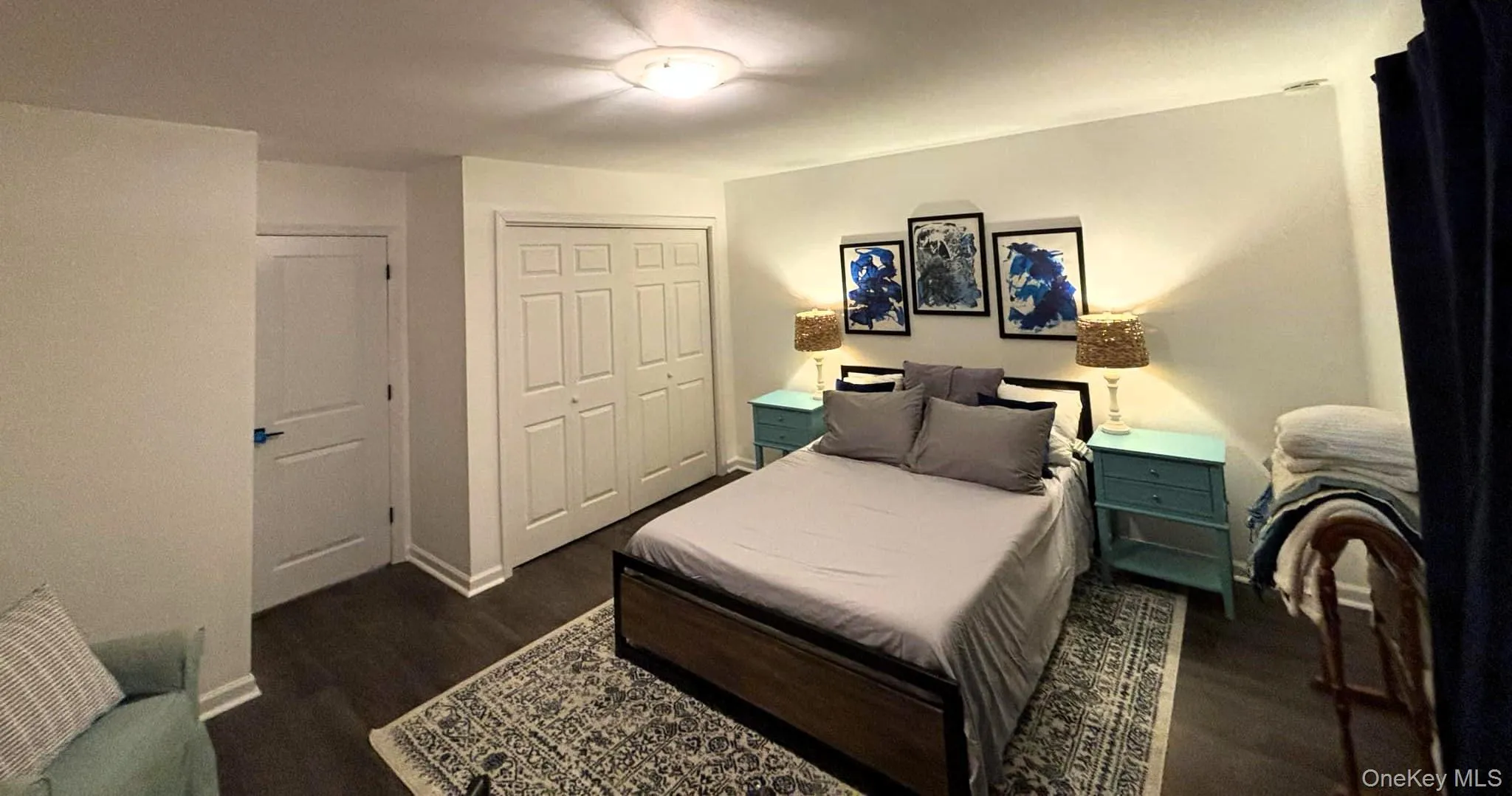 Bedroom with a closet and dark wood-style flooring Bedroom with a closet and dark wood-style flooring