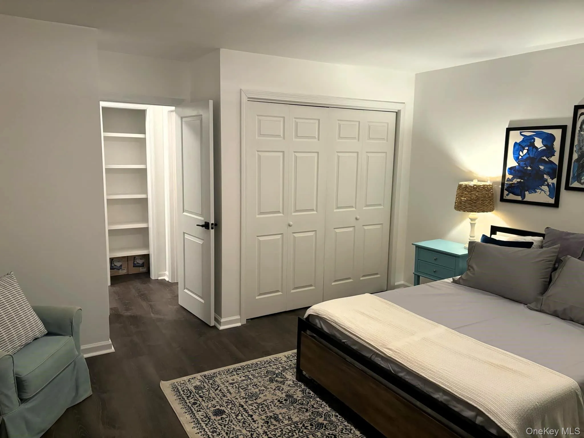 Bedroom with a closet and dark wood finished floors Bedroom with a closet and dark wood finished floors