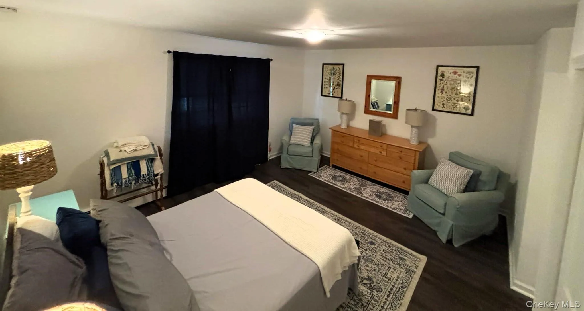 Bedroom featuring dark wood finished floors Bedroom featuring dark wood finished floors