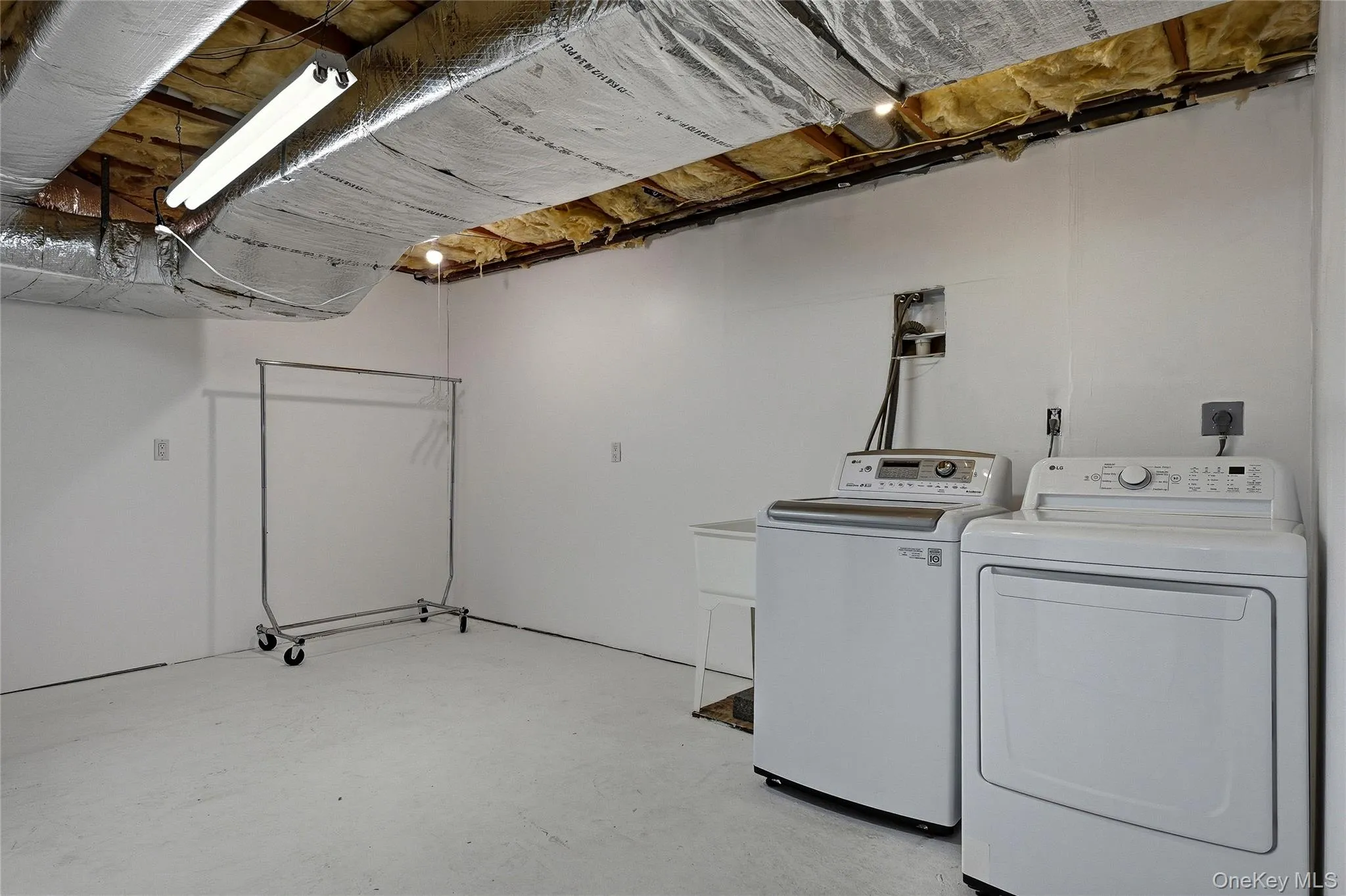 Laundry area featuring concrete floors and independent washer and dryer Laundry area featuring concrete floors and independent washer and dryer