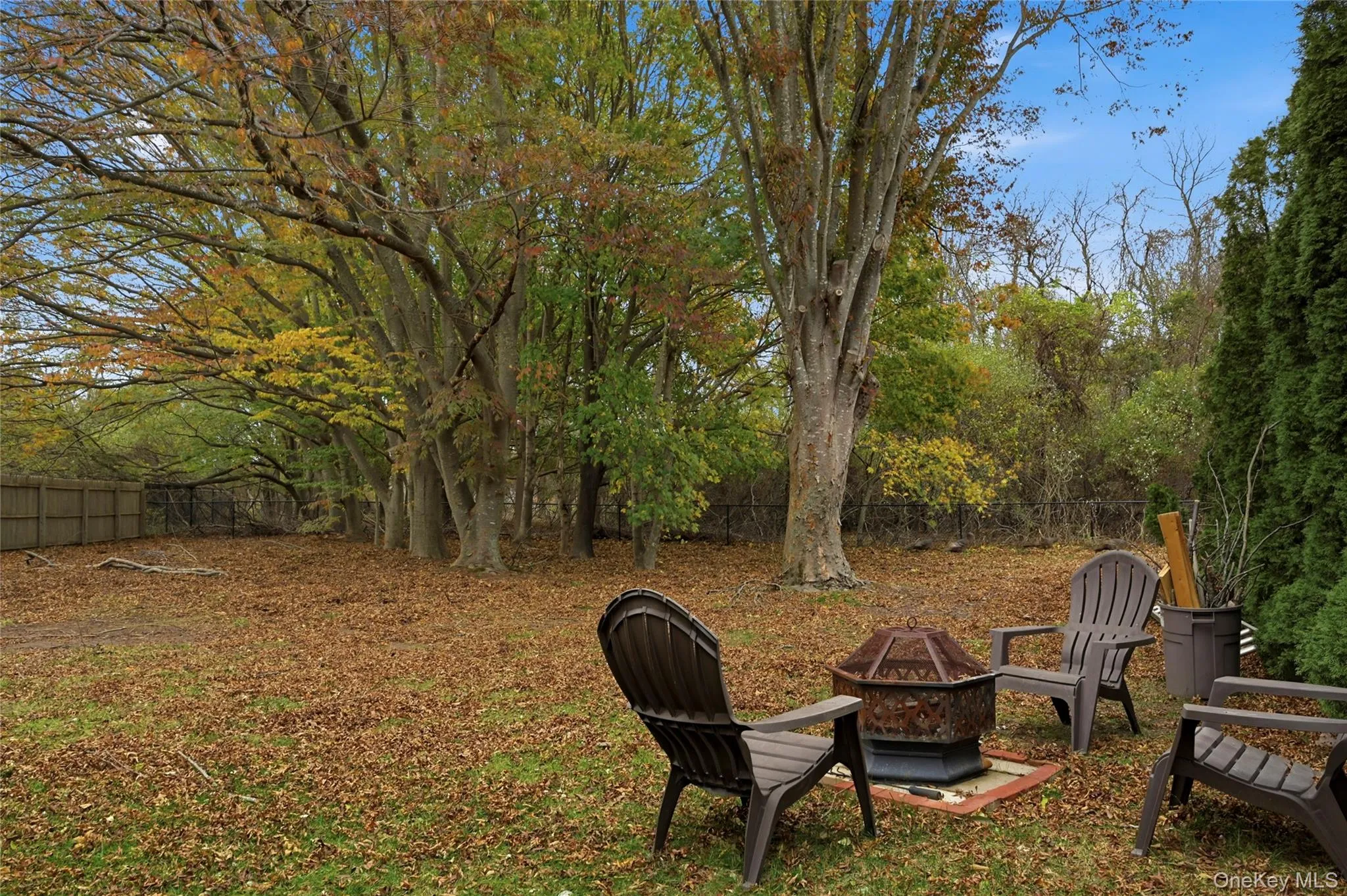 Fenced backyard with a fire pit Fenced backyard with a fire pit