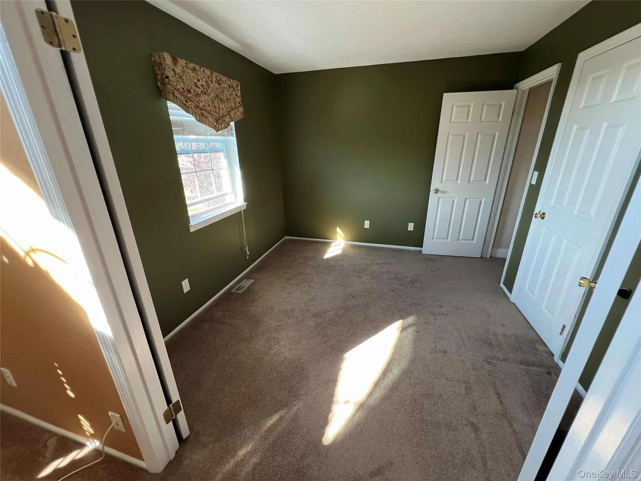 Unfurnished bedroom with carpet Unfurnished bedroom with carpet