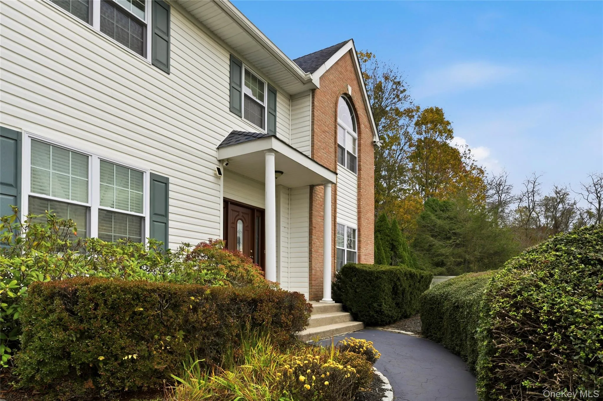 View of exterior entry with brick siding and roof with shingles View of exterior entry with brick siding and roof with shingles