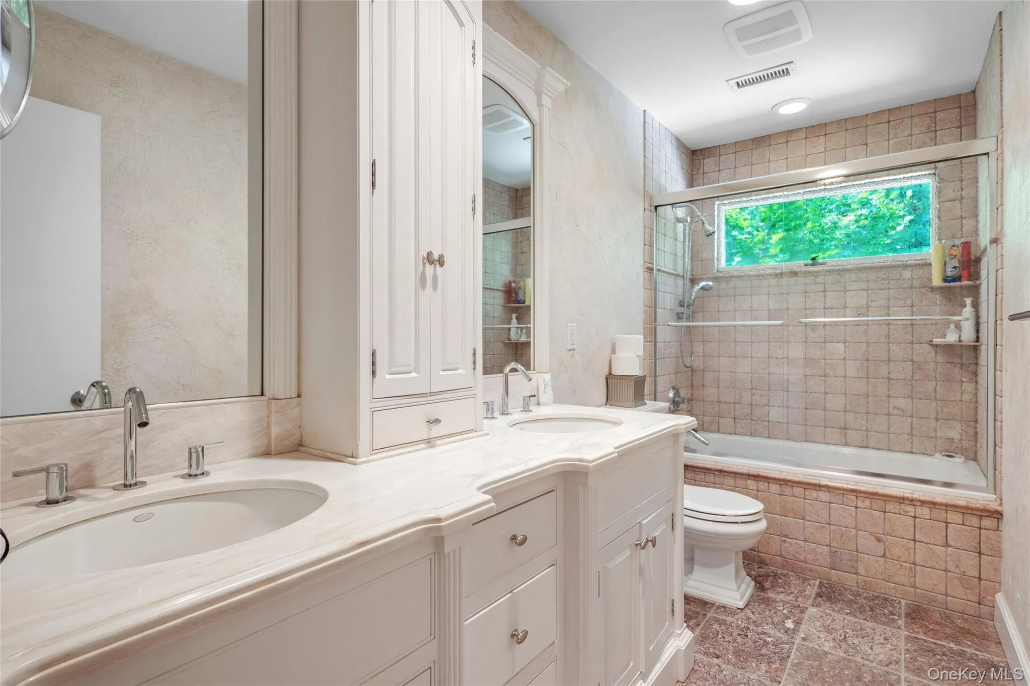 Bathroom with double vanity and tiled shower / bath combo Bathroom with double vanity and tiled shower / bath combo