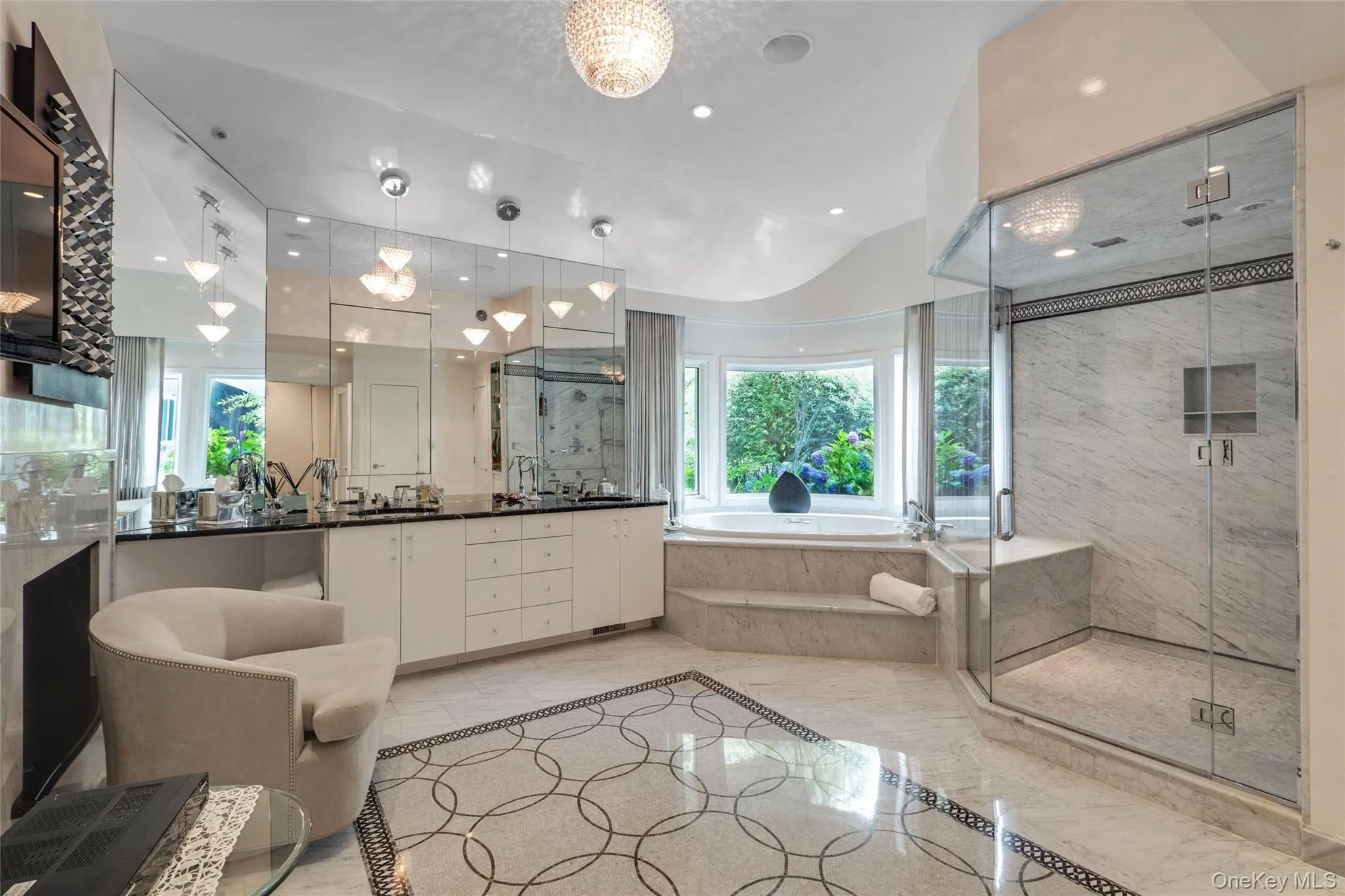 Full bathroom featuring a garden tub, double vanity, a marble finish shower, light marble finish flooring, and lofted ceiling Full bathroom featuring a garden tub, double vanity, a marble finish shower, light marble finish flooring, and lofted ceiling