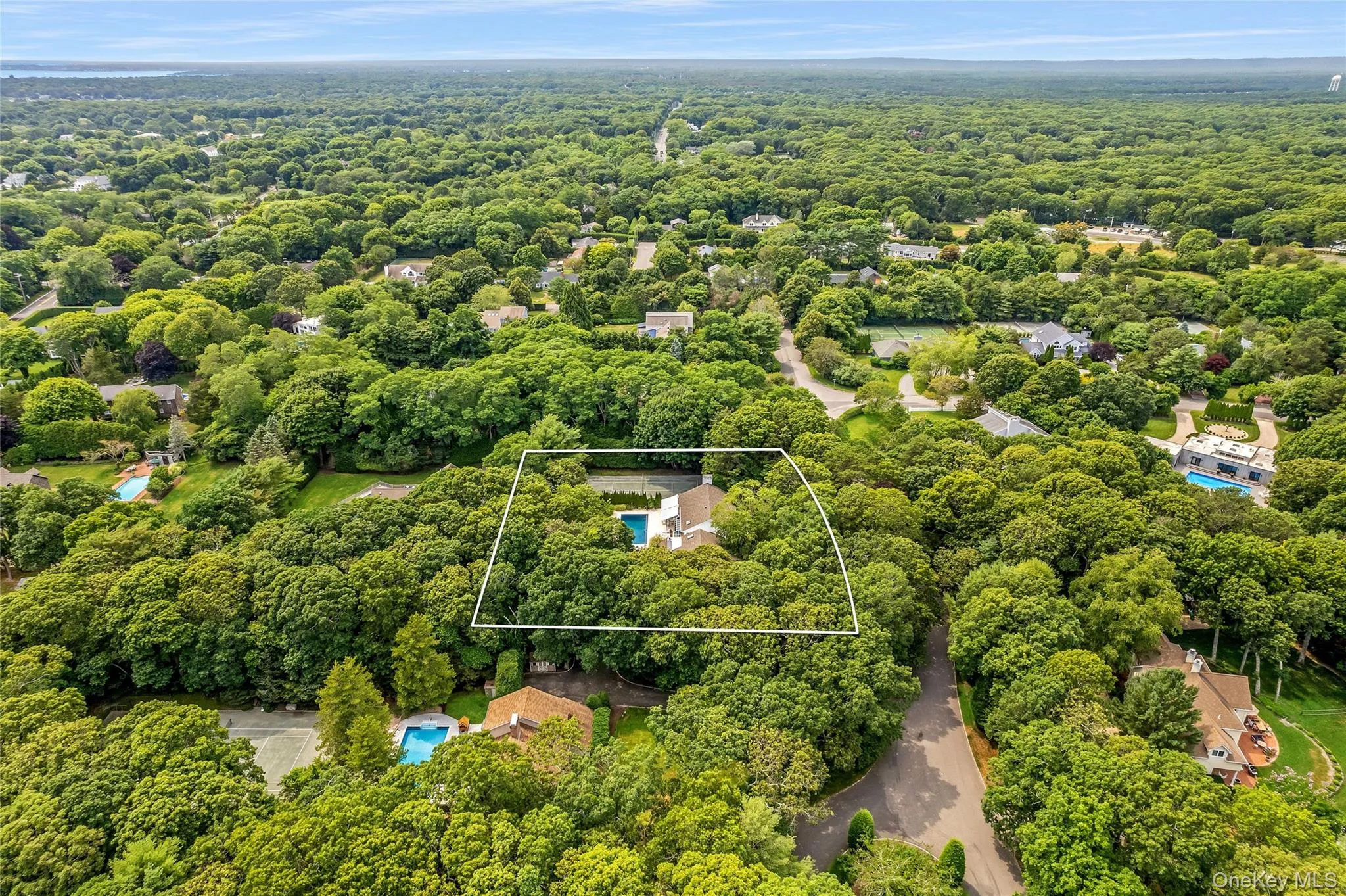 Aerial view of property and surrounding area featuring a heavily wooded area and property boundaries highlighted Aerial view of property and surrounding area featuring a heavily wooded area and property boundaries highlighted