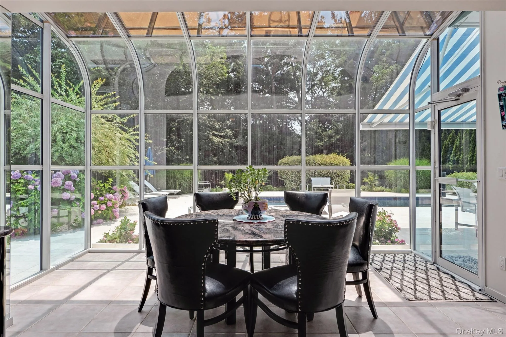 Sunroom with view of wooded area Sunroom with view of wooded area