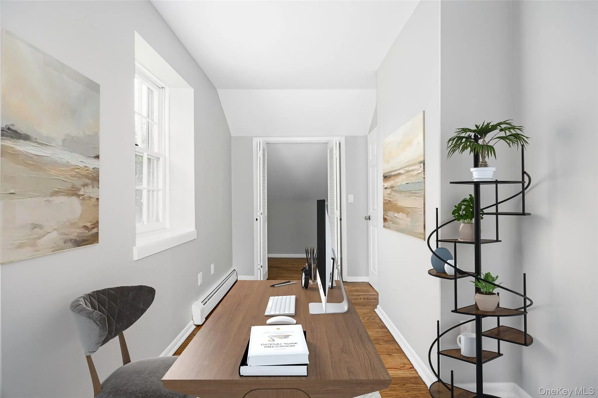 Office with wood finished floors, a baseboard heating unit, and lofted ceiling Office with wood finished floors, a baseboard heating unit, and lofted ceiling