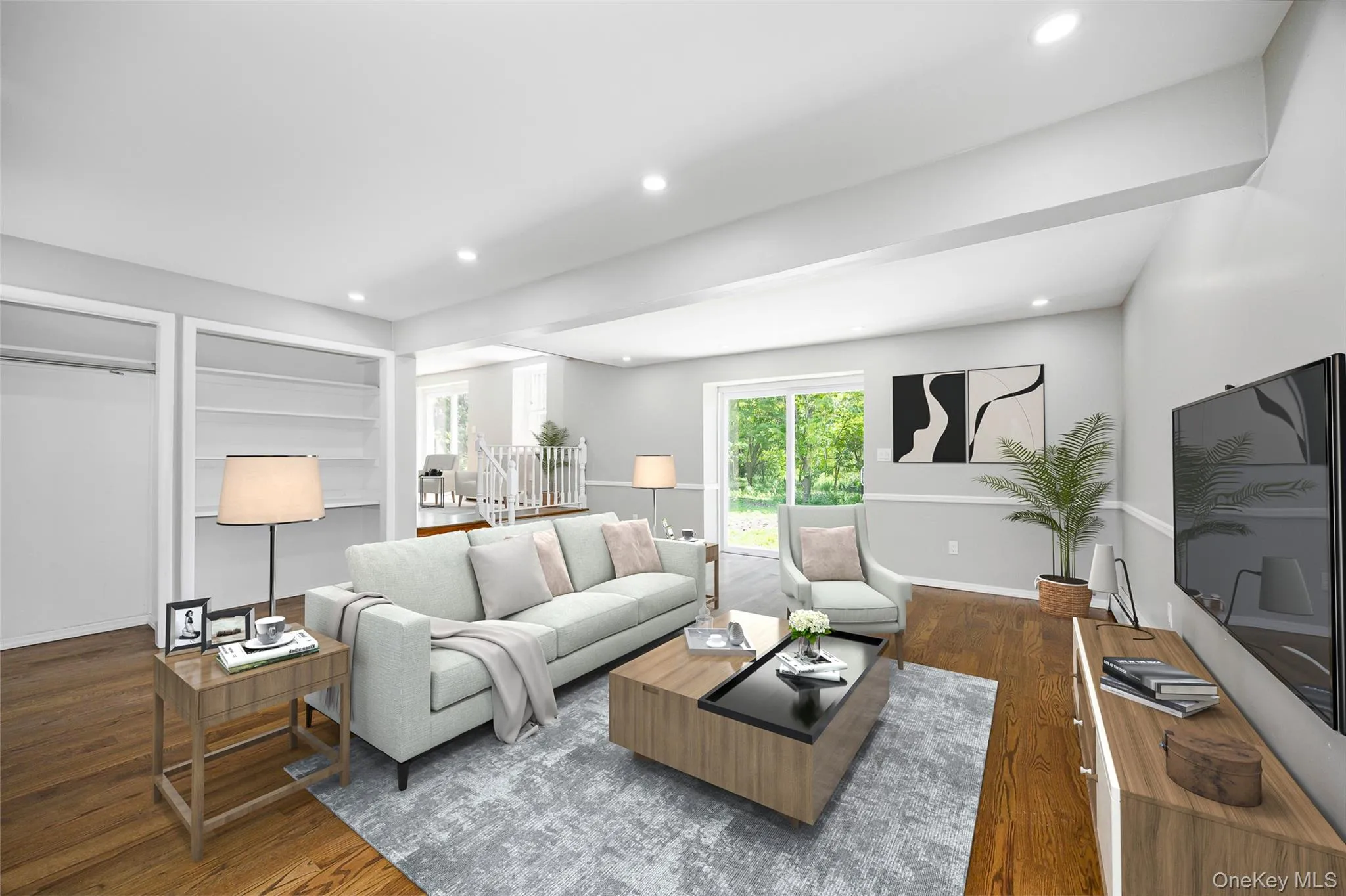 Living area with dark wood-style floors, recessed lighting, and built in shelves Living area with dark wood-style floors, recessed lighting, and built in shelves