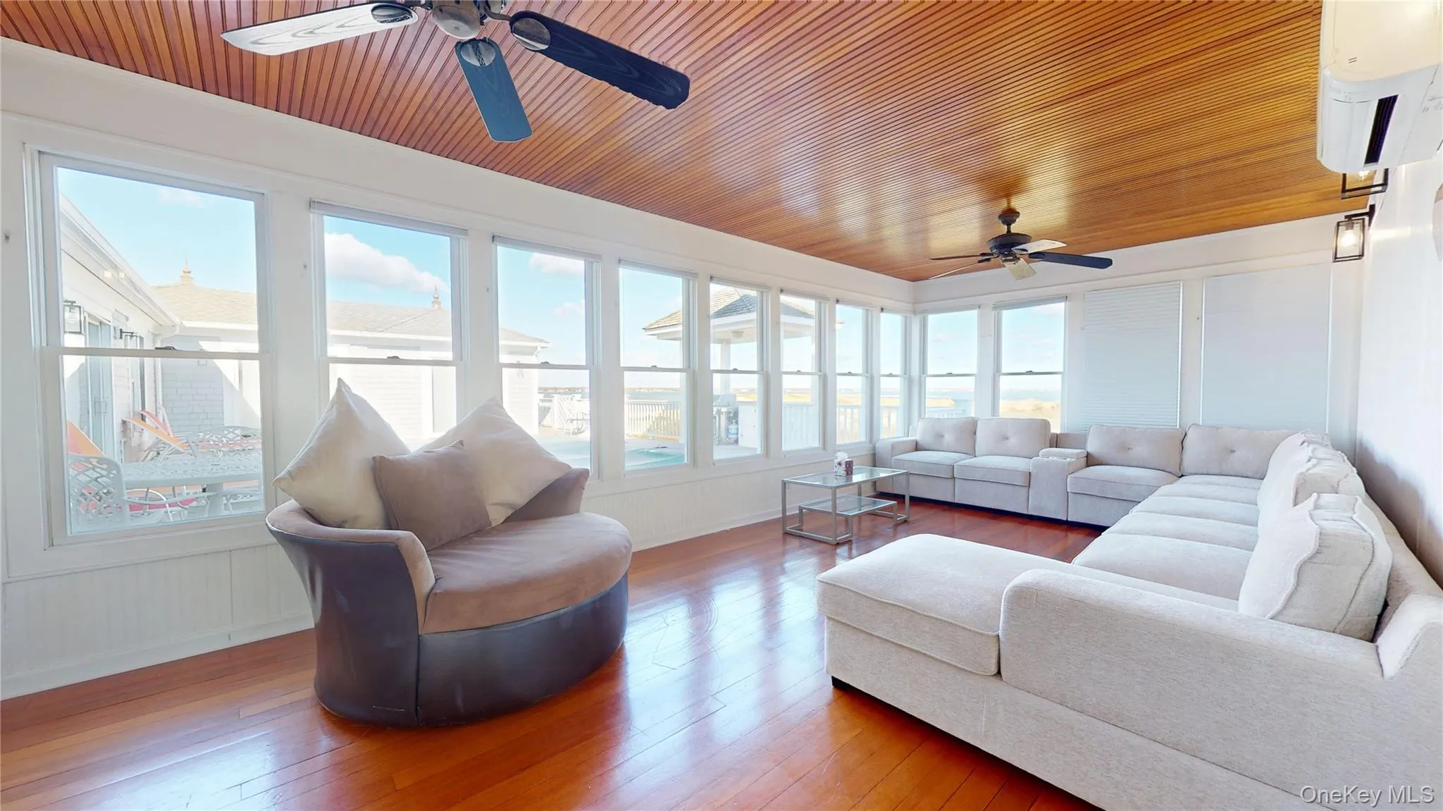 Sunroom / solarium with wood ceiling, wood-type flooring, plenty of natural light, and water heater Sunroom / solarium with wood ceiling, wood-type flooring, plenty of natural light, and water heater