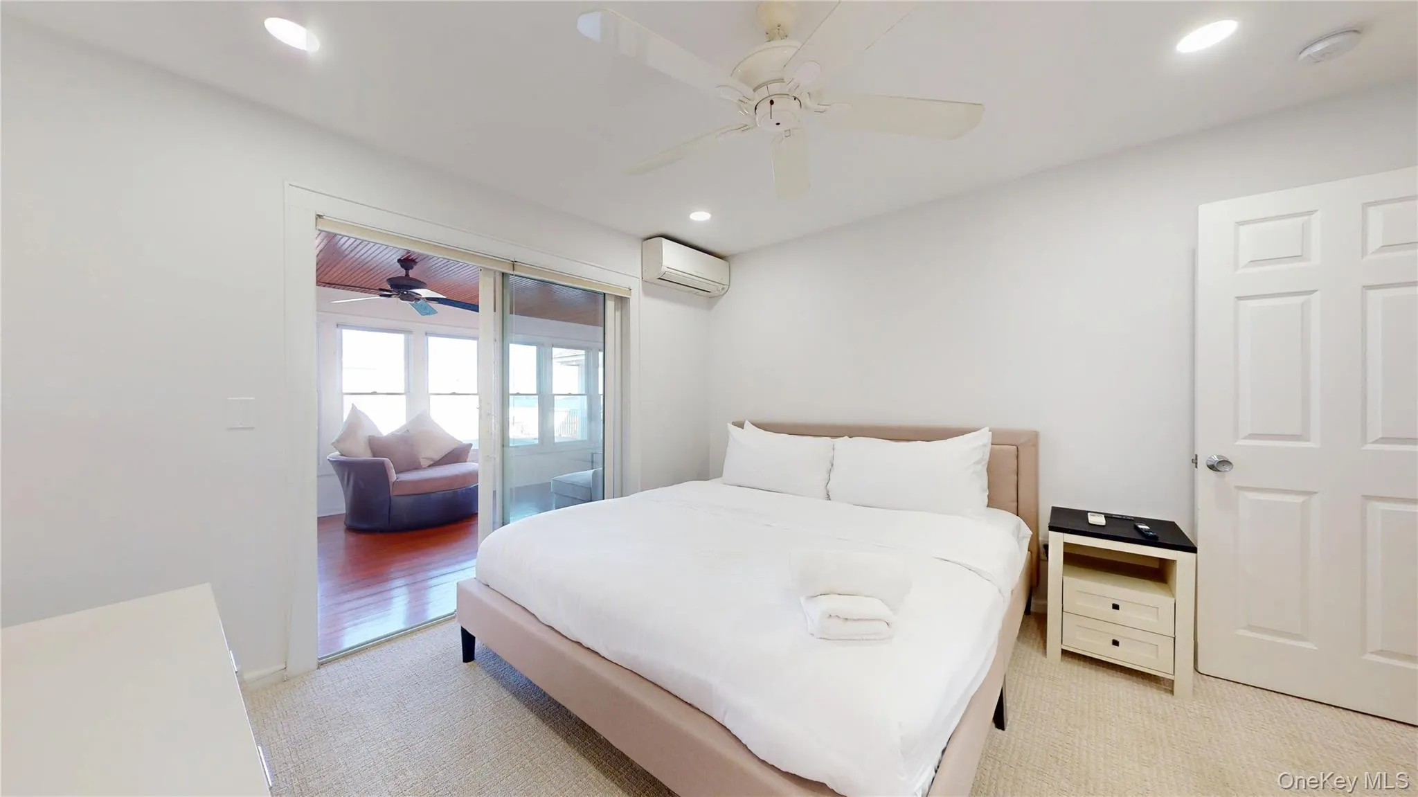Bedroom with light colored carpet, recessed lighting, a ceiling fan, a wall mounted AC, and access to exterior Bedroom with light colored carpet, recessed lighting, a ceiling fan, a wall mounted AC, and access to exterior