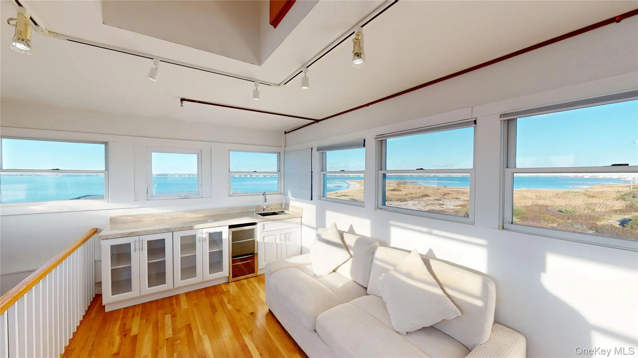 Sunroom / solarium with track lighting, healthy amount of natural light, and a water view Sunroom / solarium with track lighting, healthy amount of natural light, and a water view