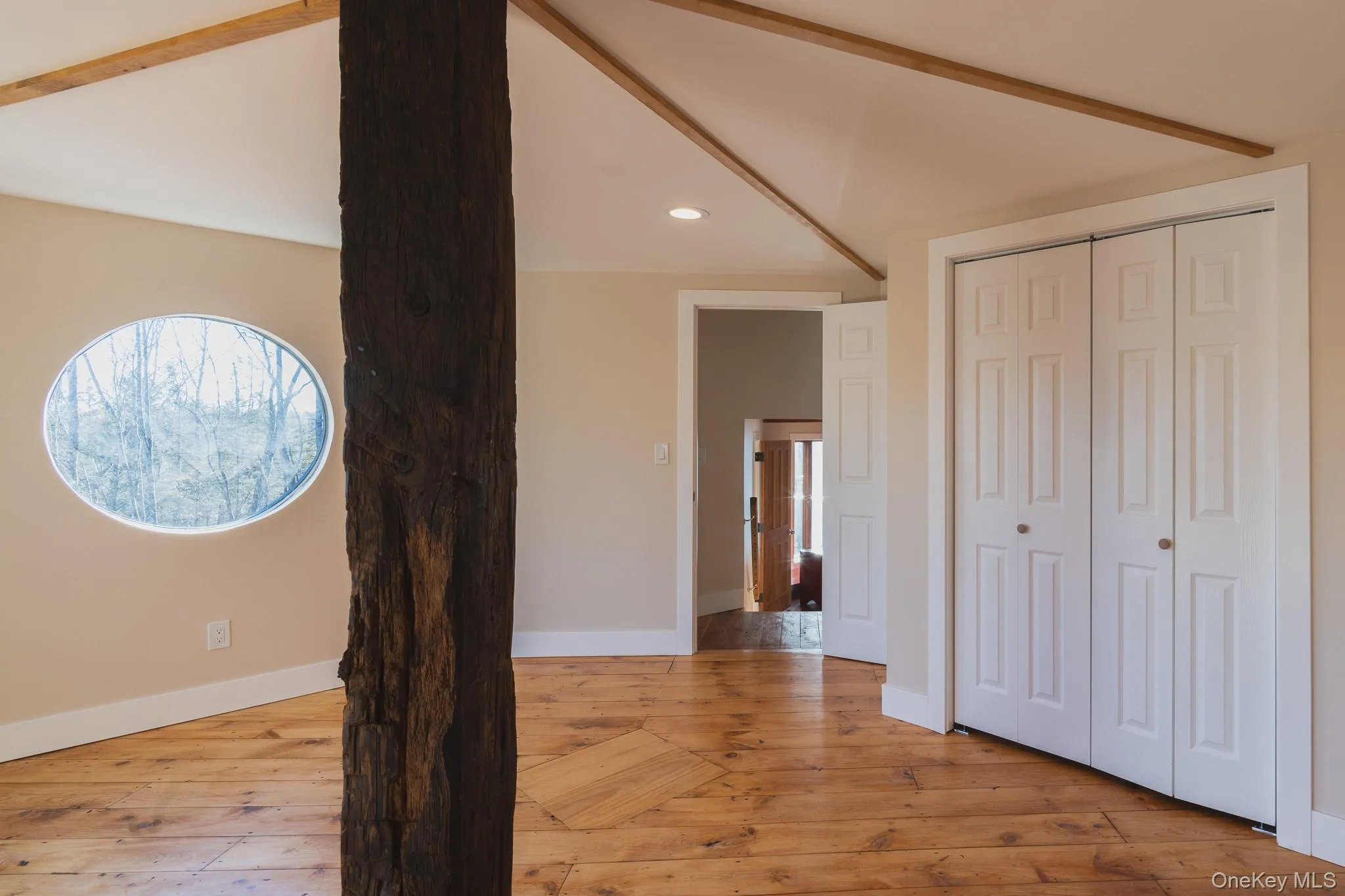 Hallway with recessed lighting and light wood finished floors Hallway with recessed lighting and light wood finished floors