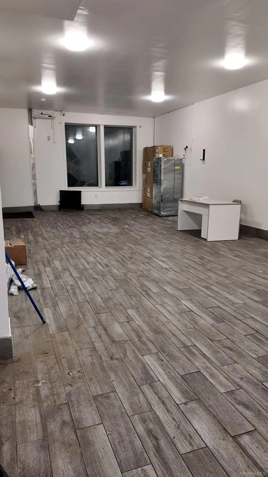 Basement featuring wood finished floors and baseboards Basement featuring wood finished floors and baseboards