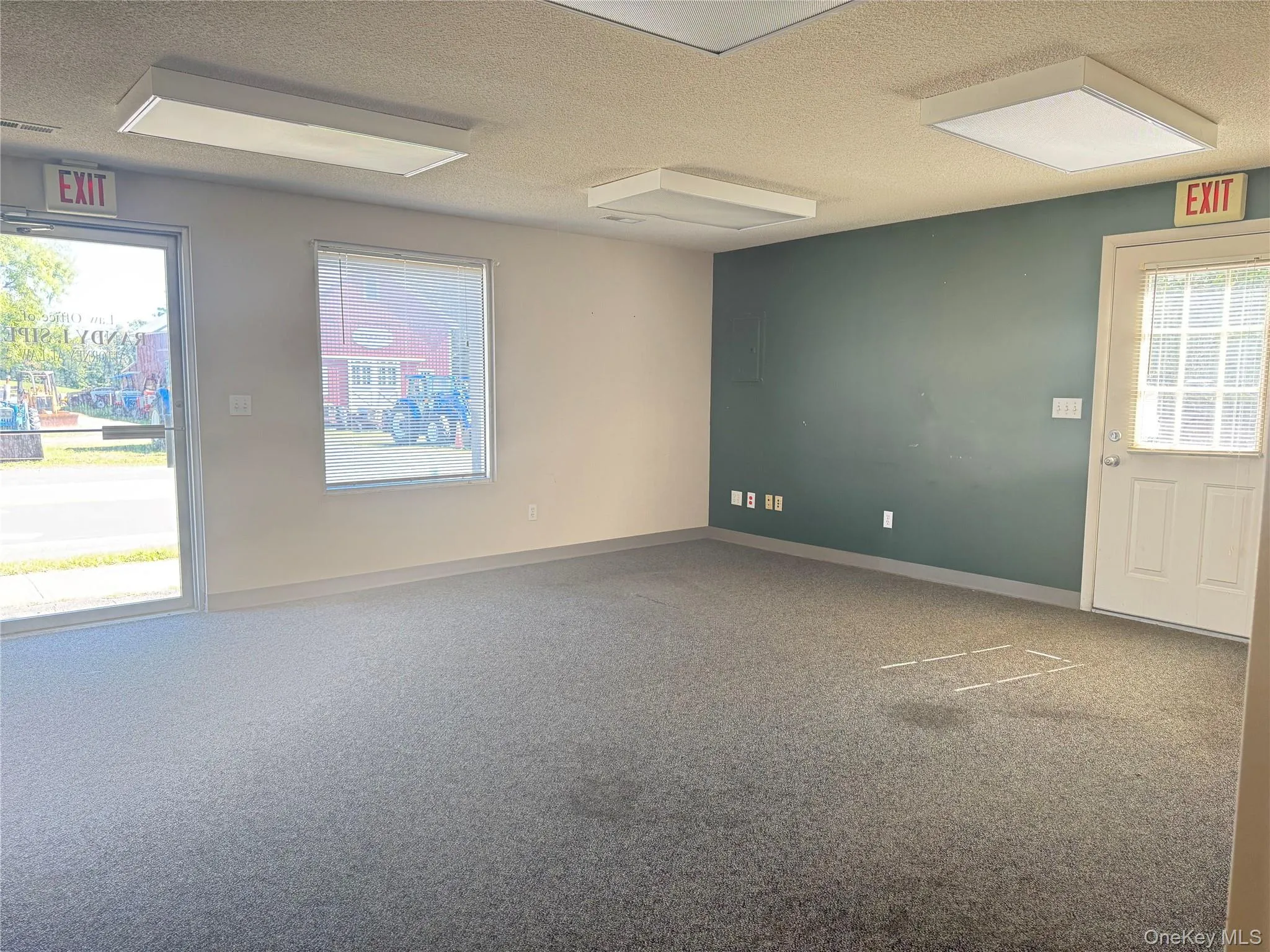Carpeted spare room with a textured ceiling Carpeted spare room with a textured ceiling