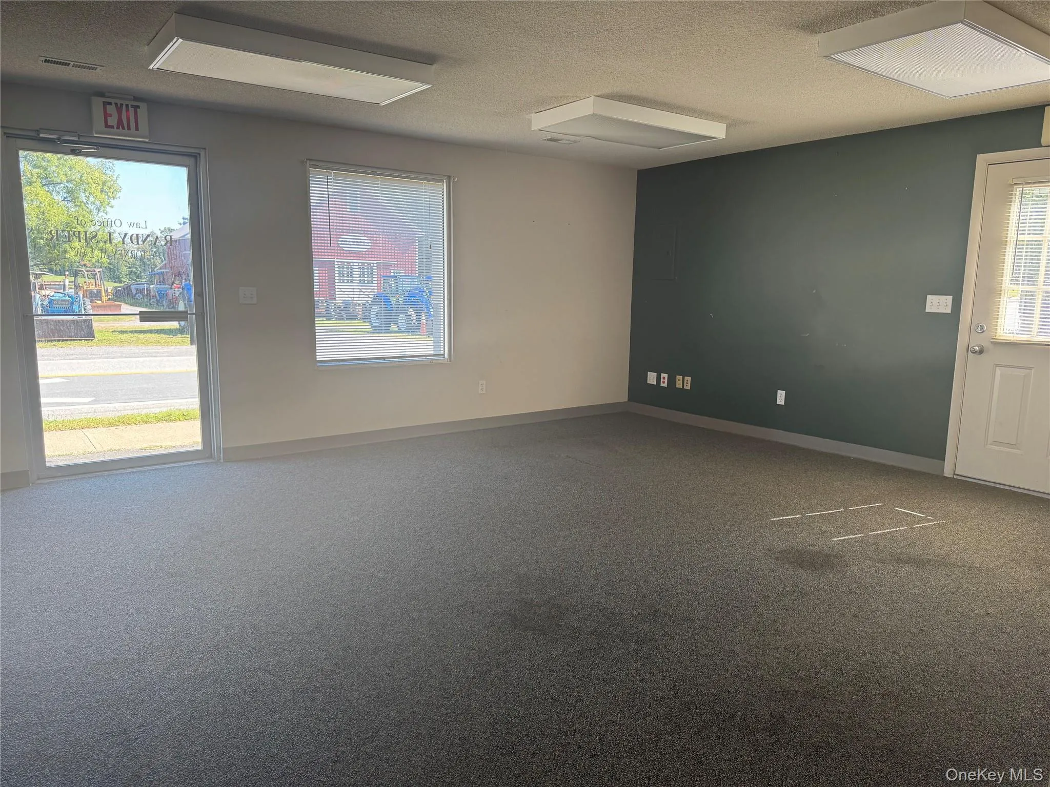 Empty room with carpet and a textured ceiling Empty room with carpet and a textured ceiling