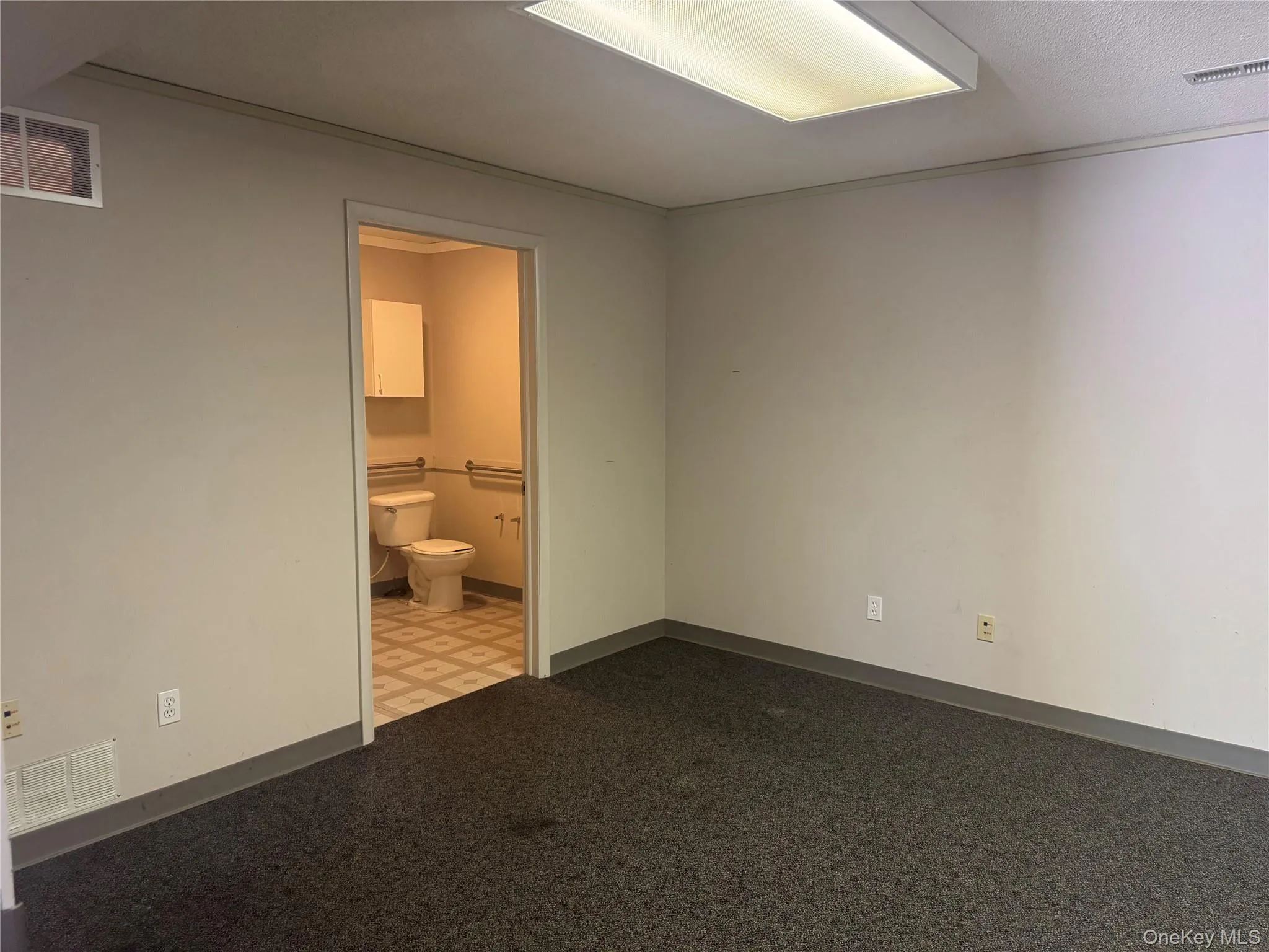 Unfurnished bedroom featuring connected bathroom and light floors Unfurnished bedroom featuring connected bathroom and light floors