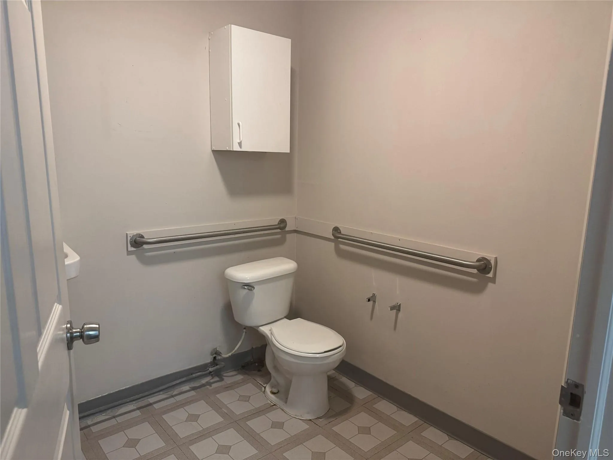 Half bathroom featuring toilet and baseboards Half bathroom featuring toilet and baseboards