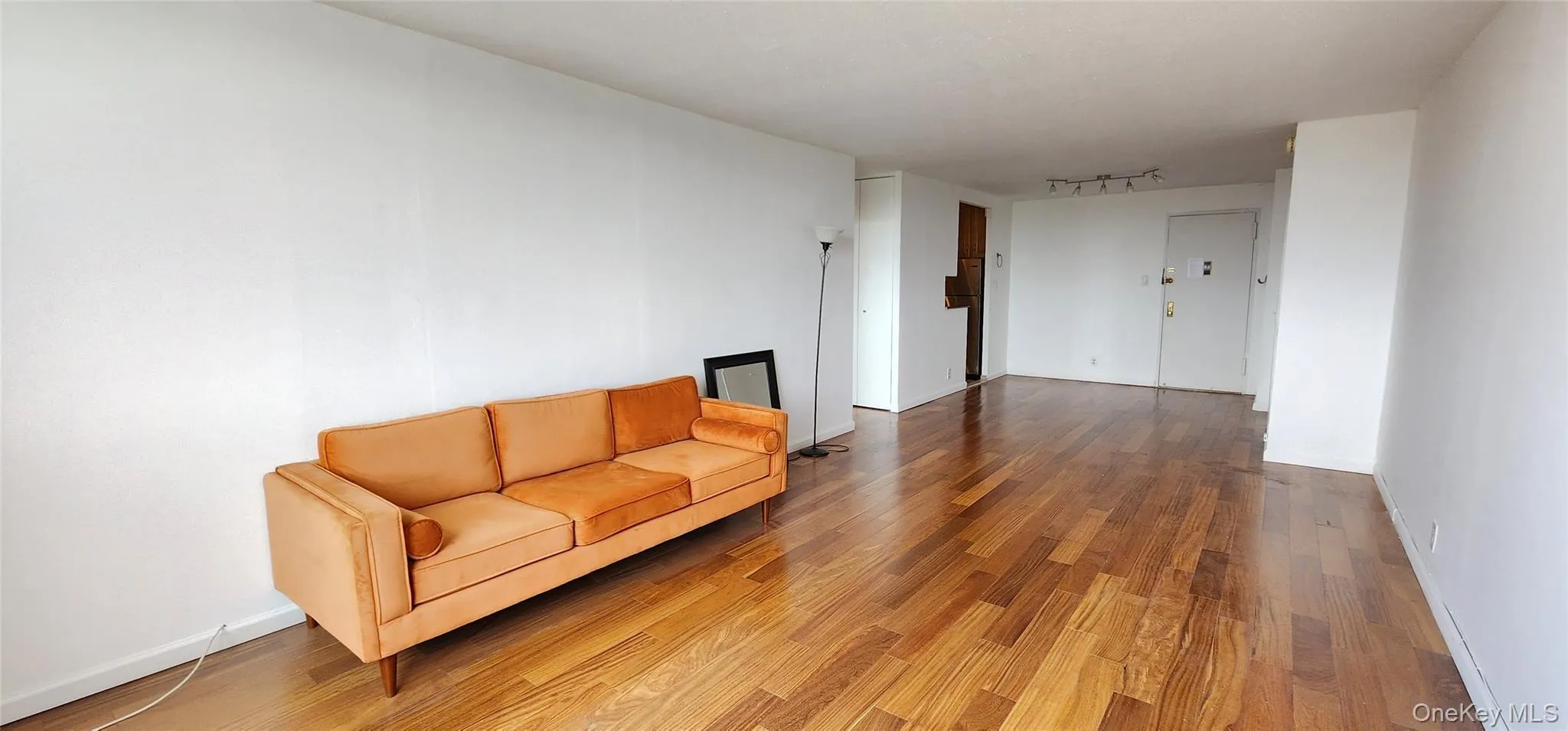 Unfurnished room with wood finished floors and track lighting Unfurnished room with wood finished floors and track lighting