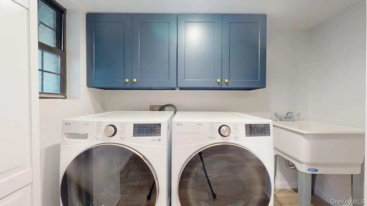 Laundry room featuring cabinet space and washing machine and clothes dryer Laundry room featuring cabinet space and washing machine and clothes dryer