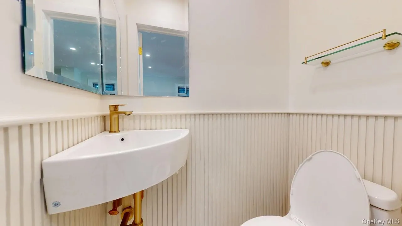 Half bath featuring wainscoting Half bath featuring wainscoting