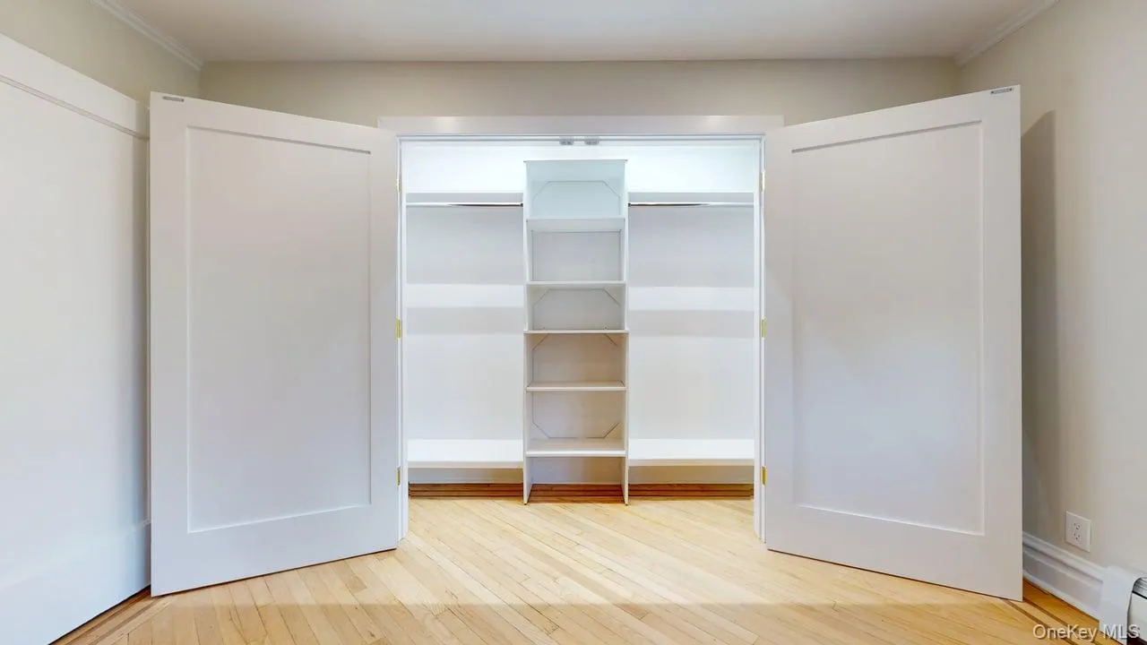Closet featuring a baseboard heating unit Closet featuring a baseboard heating unit
