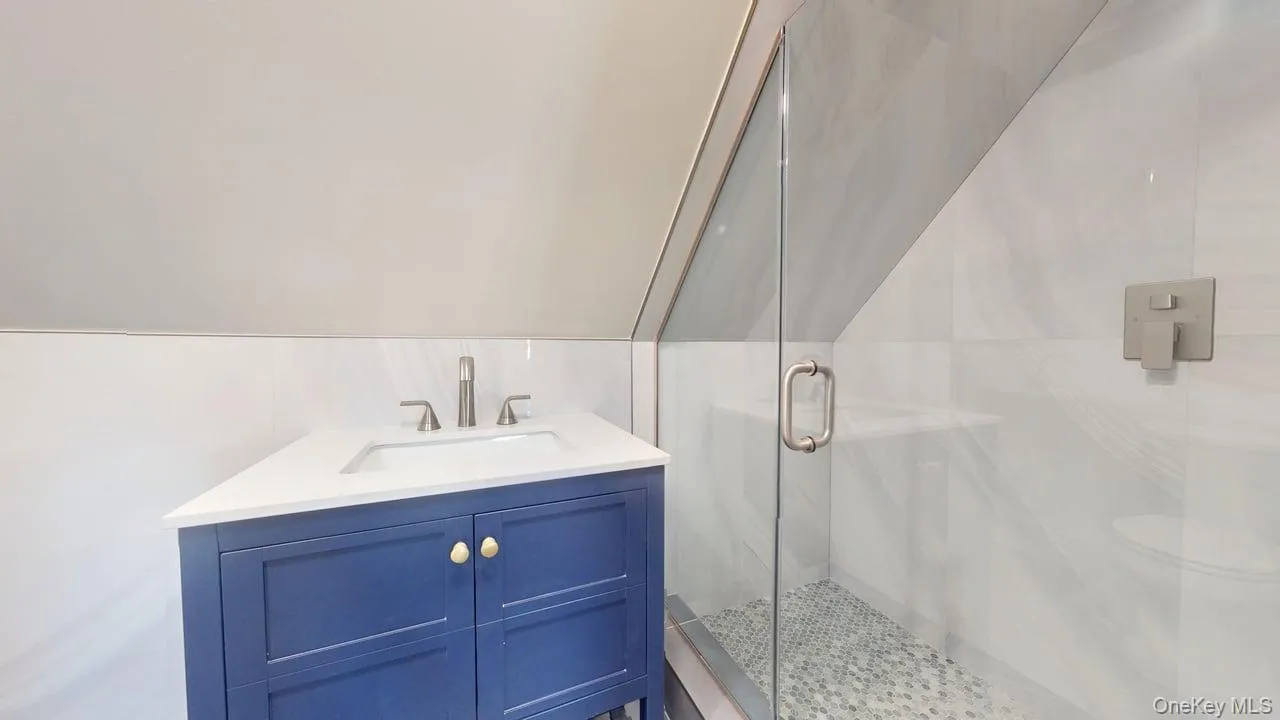 Full bathroom with vanity and a marble finish shower Full bathroom with vanity and a marble finish shower