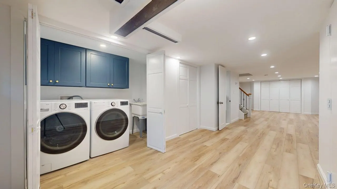 Laundry area with cabinet space, recessed lighting, light wood-type flooring, and washing machine and dryer Laundry area with cabinet space, recessed lighting, light wood-type flooring, and washing machine and dryer