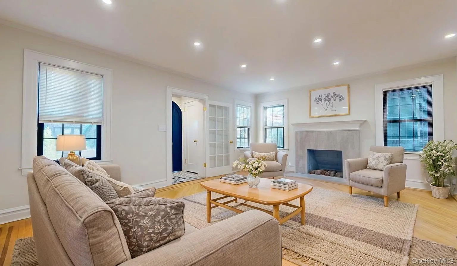 Living area featuring a high end fireplace, wood finished floors, and recessed lighting Living area featuring a high end fireplace, wood finished floors, and recessed lighting