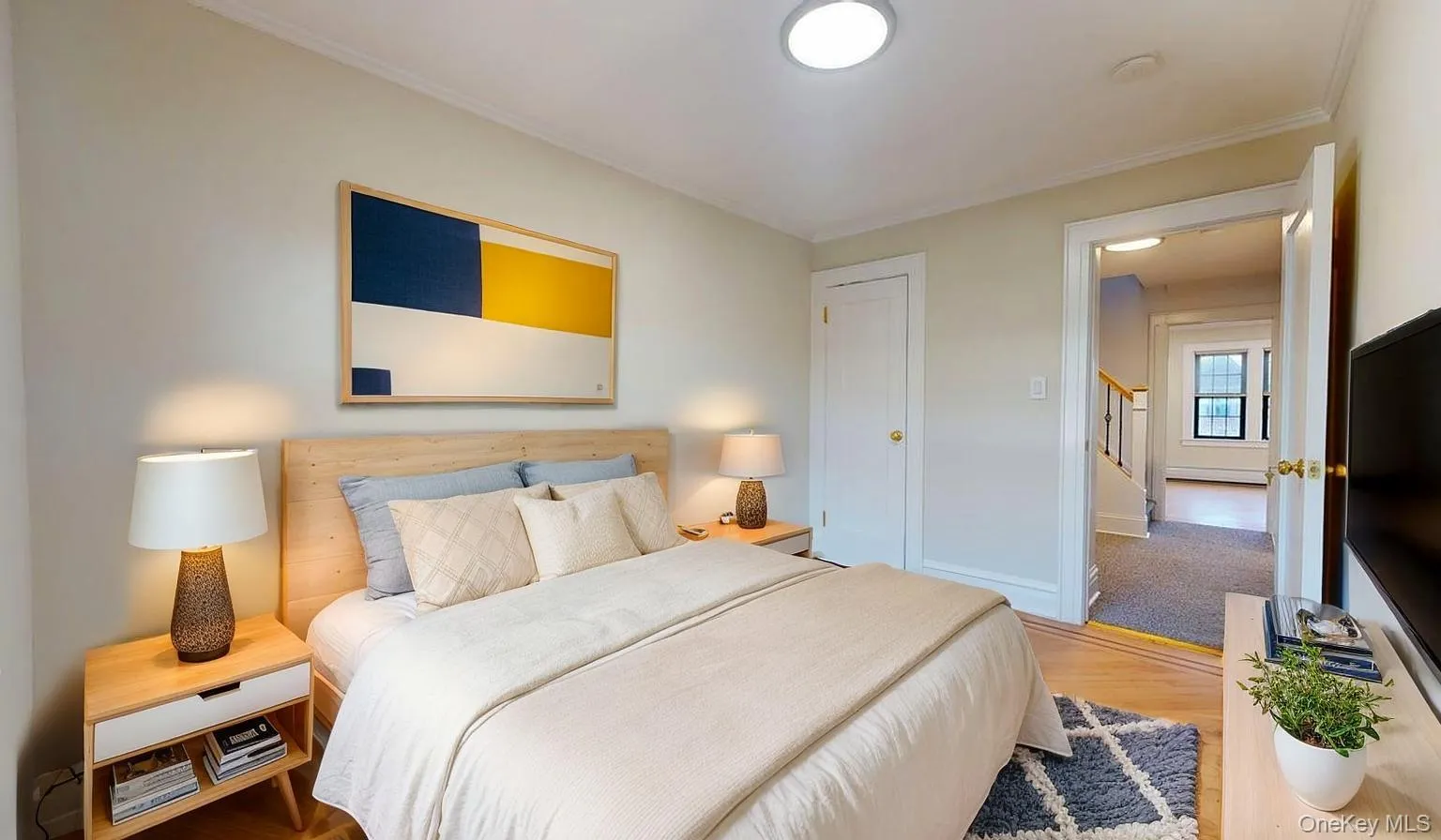 Bedroom with wood finished floors and crown molding Bedroom with wood finished floors and crown molding