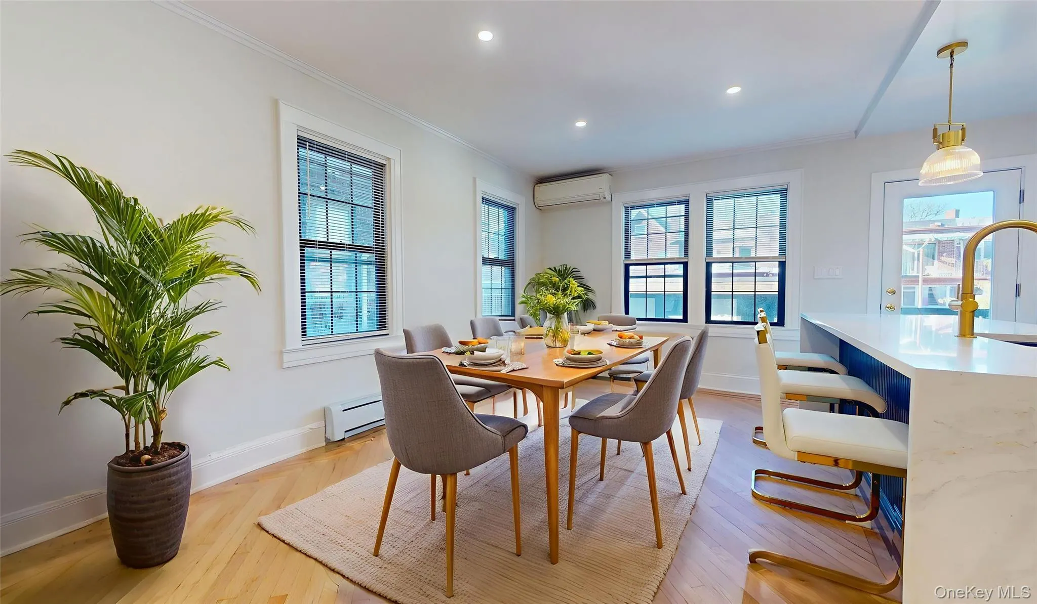 Dining area featuring a baseboard heating unit, plenty of natural light, a wall mounted air conditioner, recessed lighting, and light wood finished floors Dining area featuring a baseboard heating unit, plenty of natural light, a wall mounted air conditioner, recessed lighting, and light wood finished floors