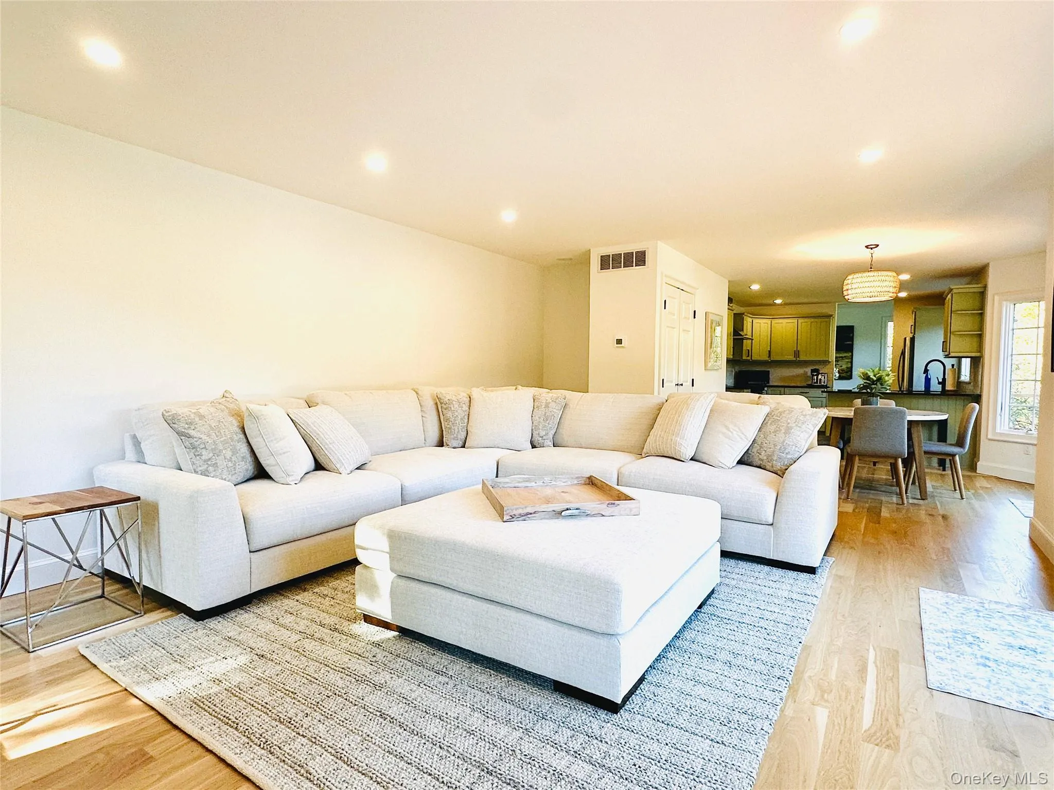 Living area with recessed lighting and light wood finished floors Living area with recessed lighting and light wood finished floors