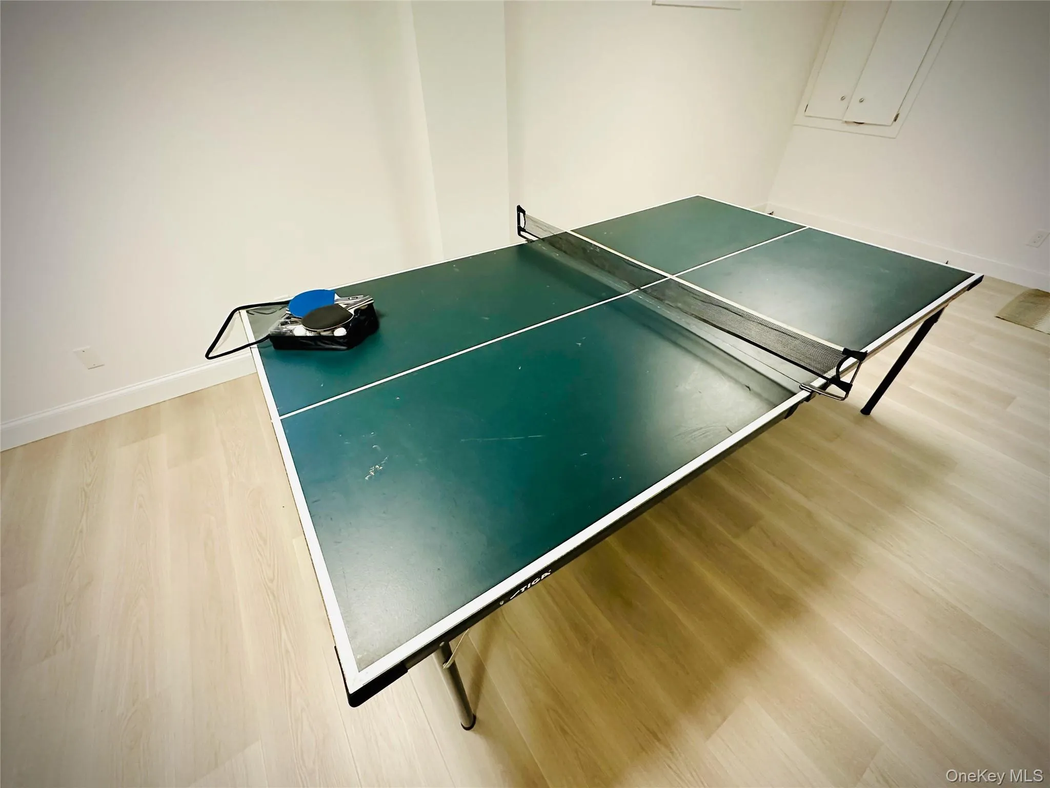 Game room featuring wood finished floors and baseboards Game room featuring wood finished floors and baseboards