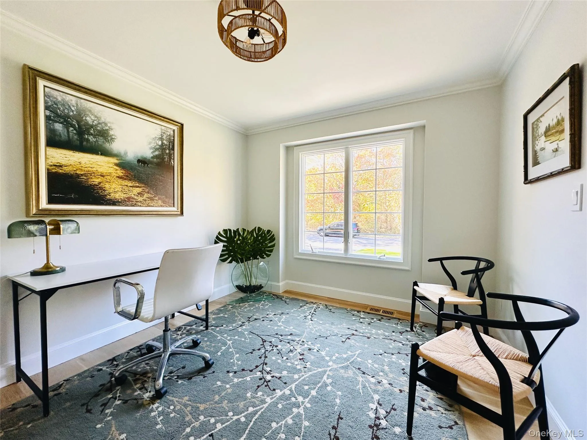 Home office featuring ornamental molding and wood finished floors Home office featuring ornamental molding and wood finished floors