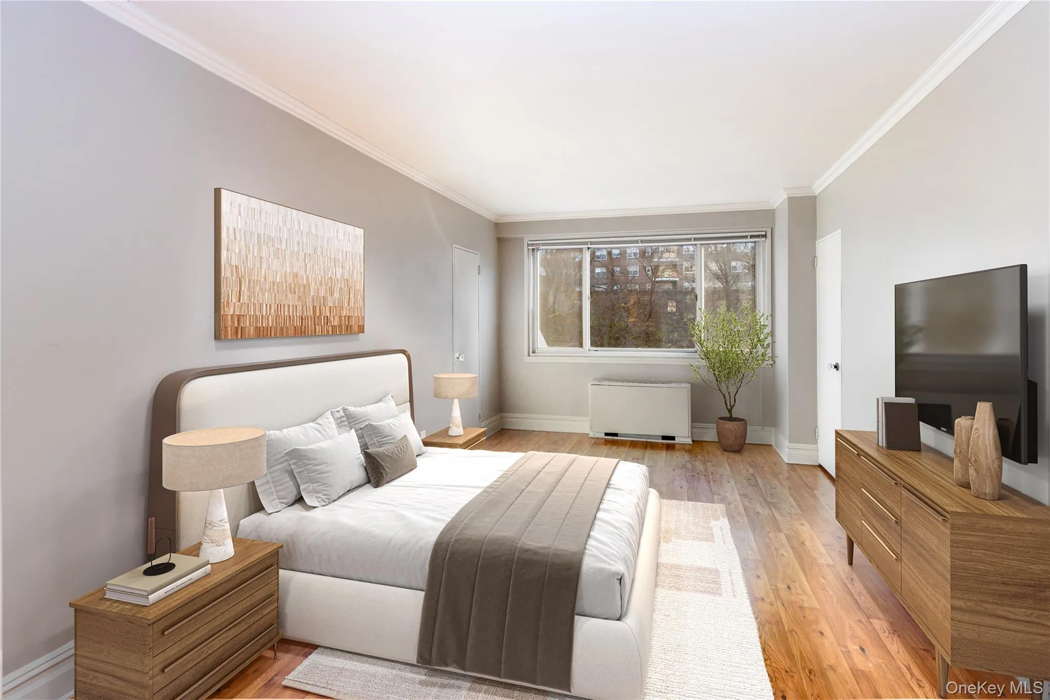 Bedroom with light wood-style flooring and crown molding Bedroom with light wood-style flooring and crown molding