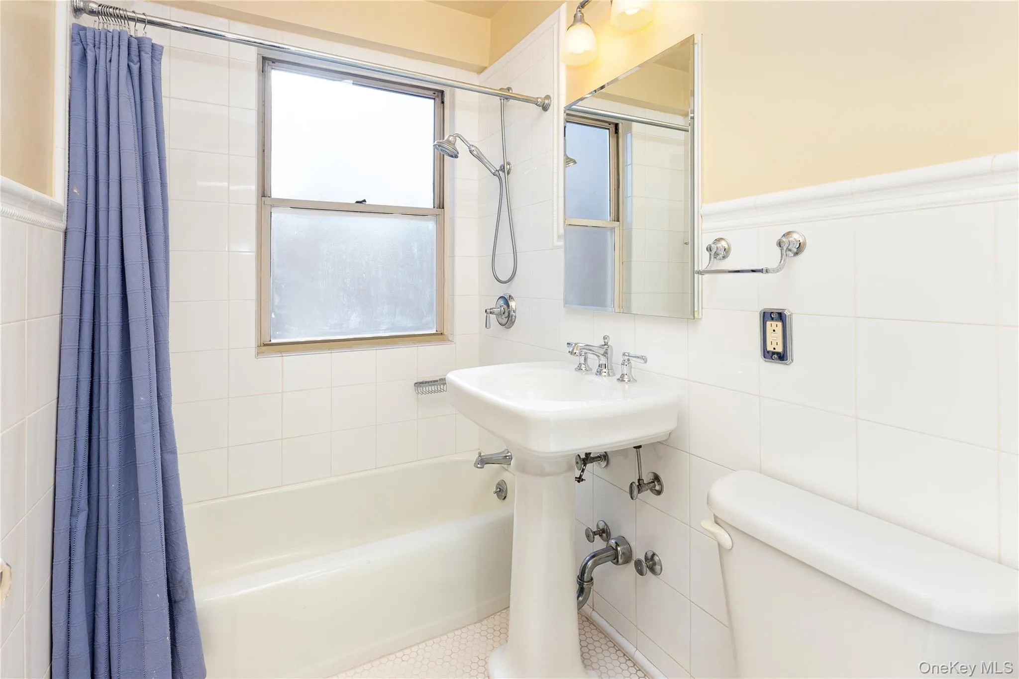 Bathroom with shower / tub combo with curtain and tile walls Bathroom with shower / tub combo with curtain and tile walls