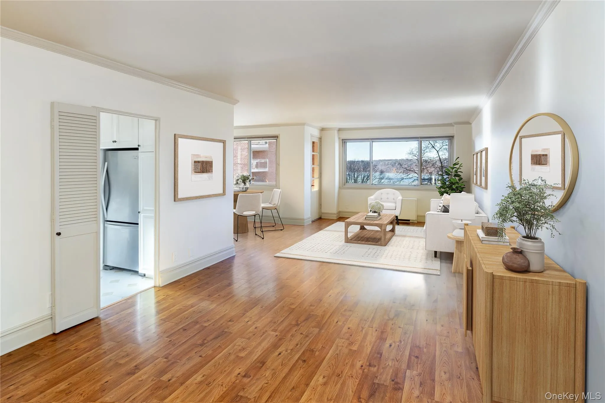 Living room featuring light wood-style floors and ornamental molding Living room featuring light wood-style floors and ornamental molding