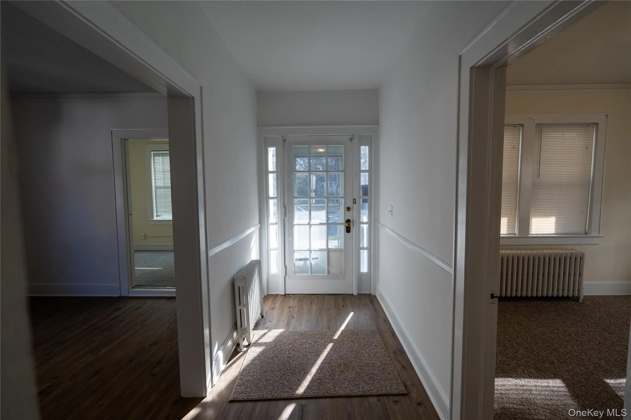 Doorway with radiator and wood finished floors Doorway with radiator and wood finished floors