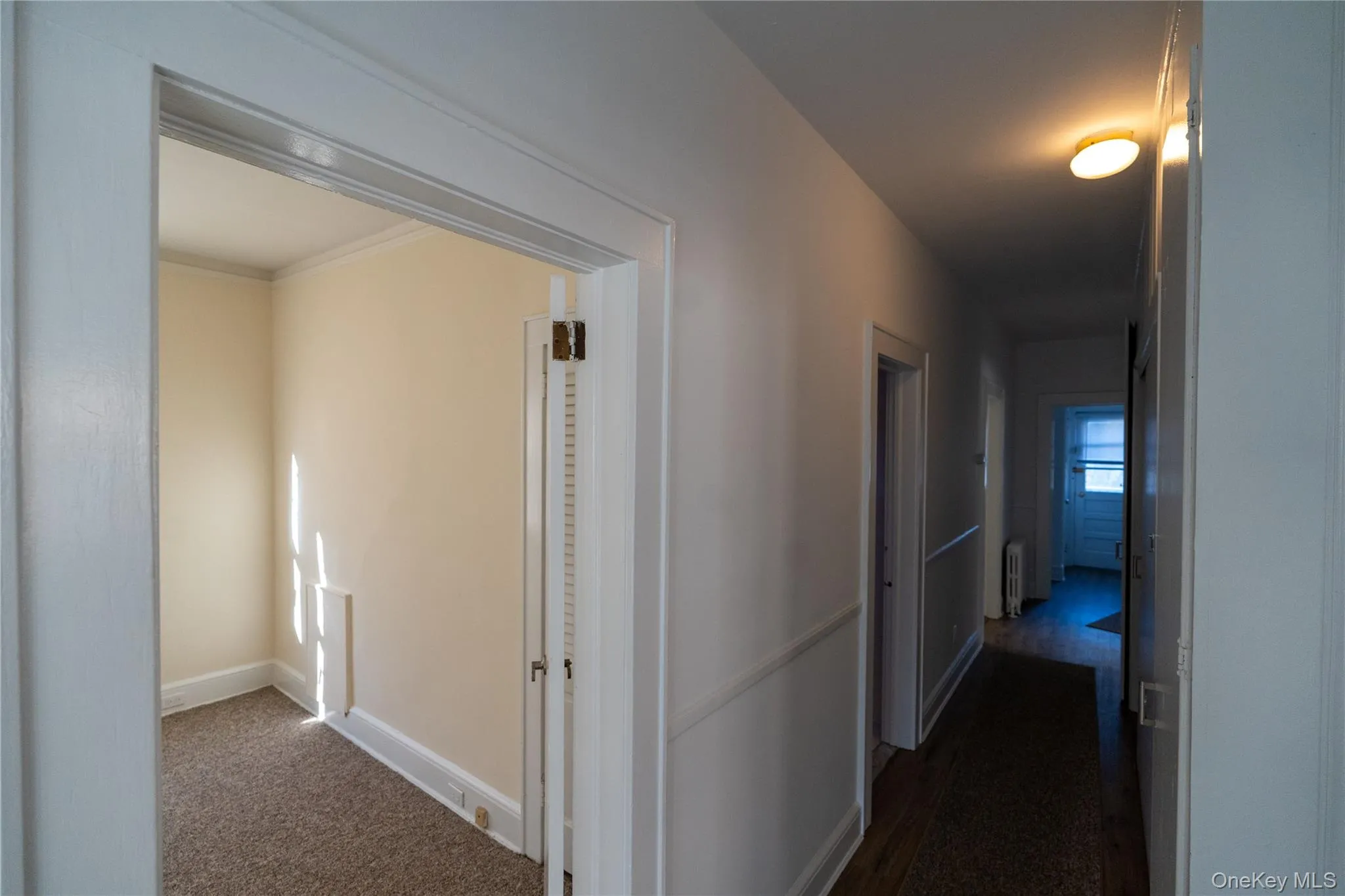 Hallway featuring baseboards and radiator Hallway featuring baseboards and radiator
