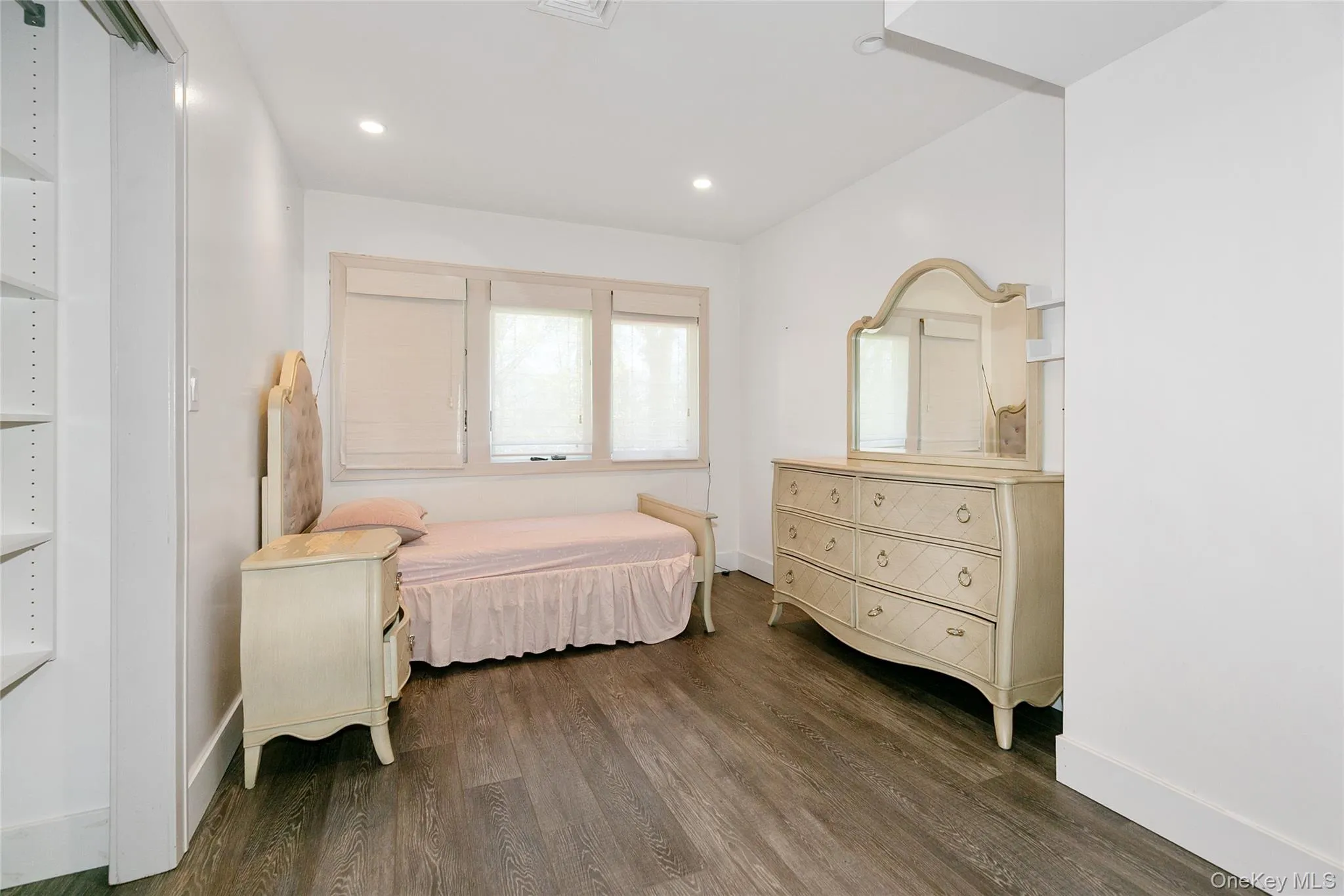 Bedroom featuring dark wood-style flooring and recessed lighting Bedroom featuring dark wood-style flooring and recessed lighting