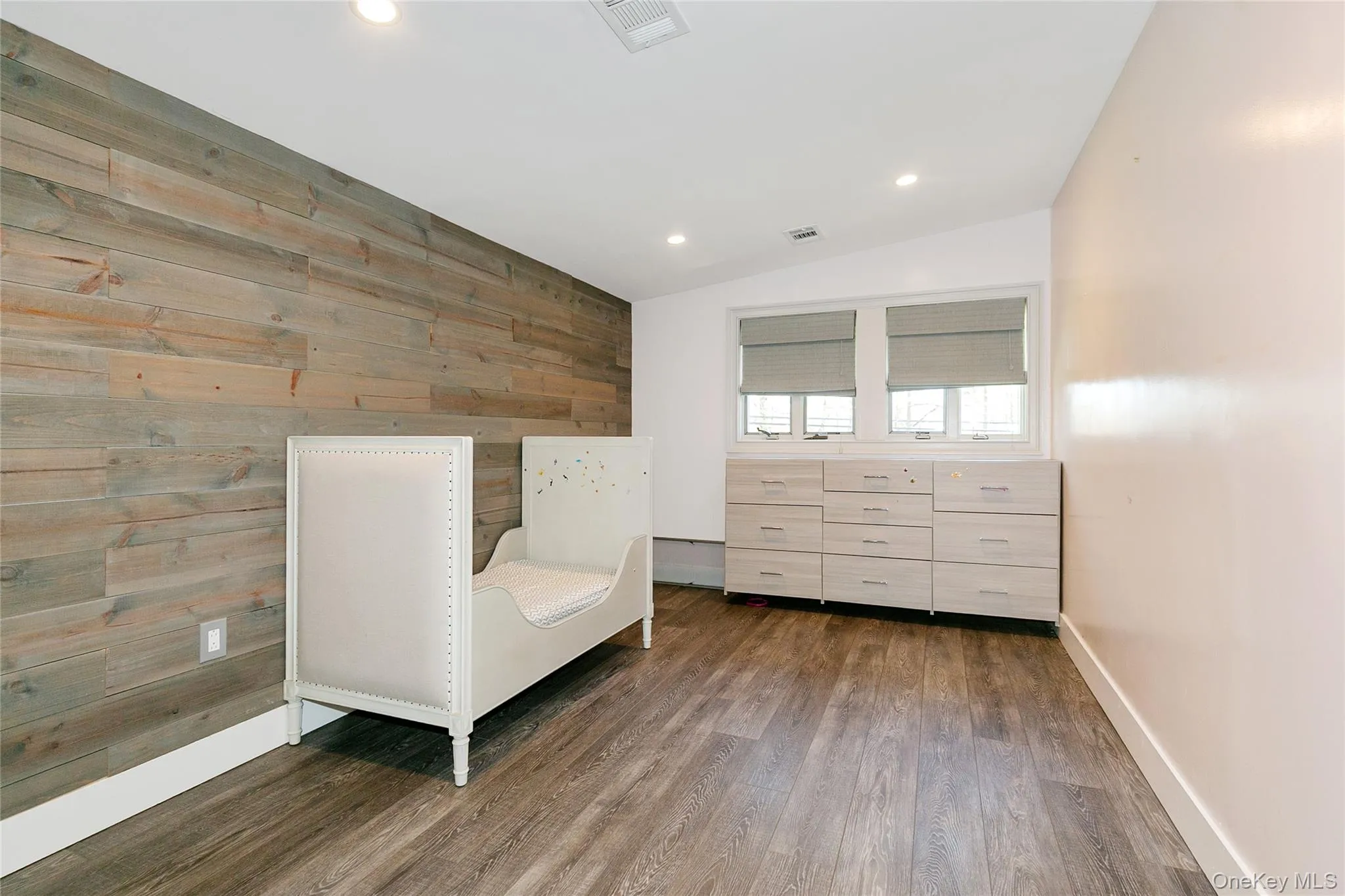 Sitting room featuring wood walls, recessed lighting, lofted ceiling, and wood finished floors Sitting room featuring wood walls, recessed lighting, lofted ceiling, and wood finished floors