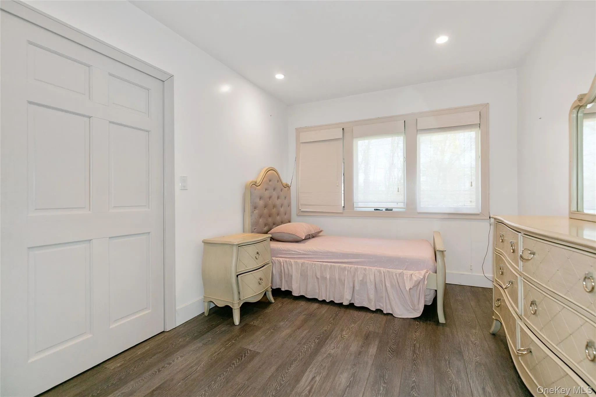 Bedroom with dark wood-style floors and recessed lighting Bedroom with dark wood-style floors and recessed lighting