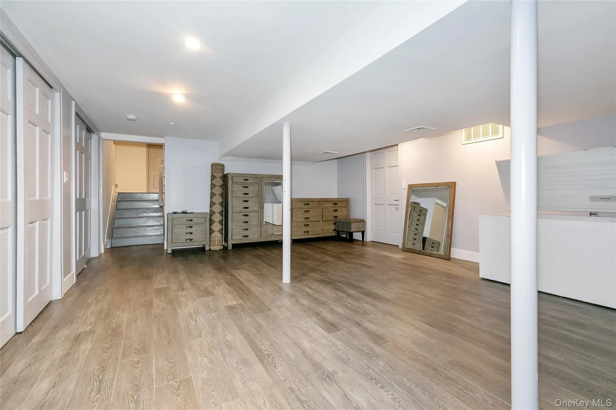 Finished basement with stairs and light wood-style floors Finished basement with stairs and light wood-style floors