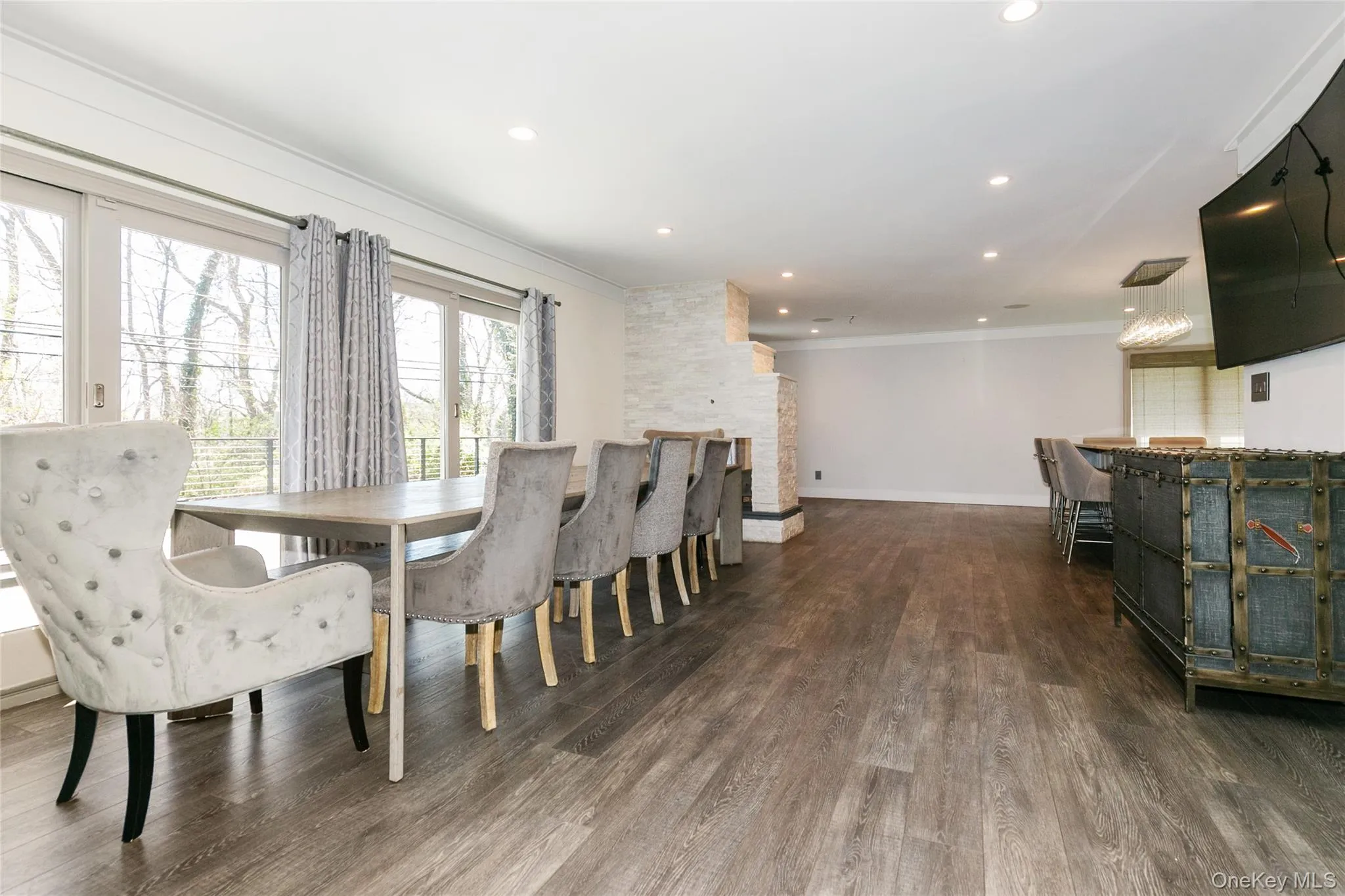 Dining room with crown molding, recessed lighting, and dark wood-type flooring Dining room with crown molding, recessed lighting, and dark wood-type flooring