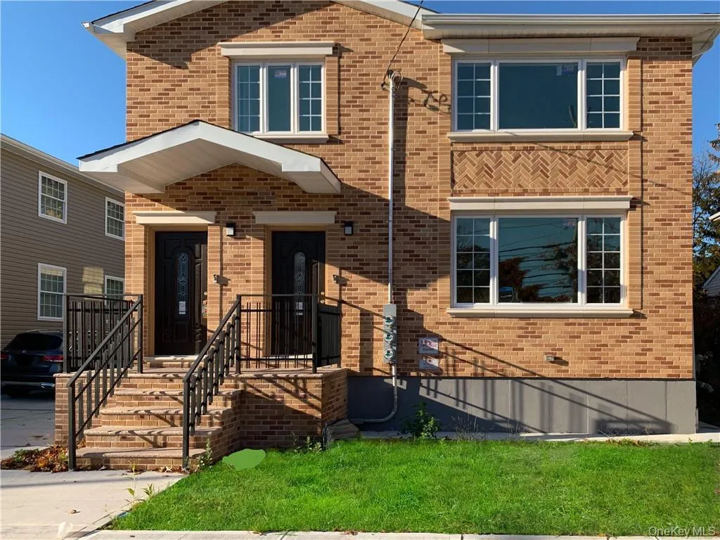 View of front facade featuring brick siding and a front lawn View of front facade featuring brick siding and a front lawn