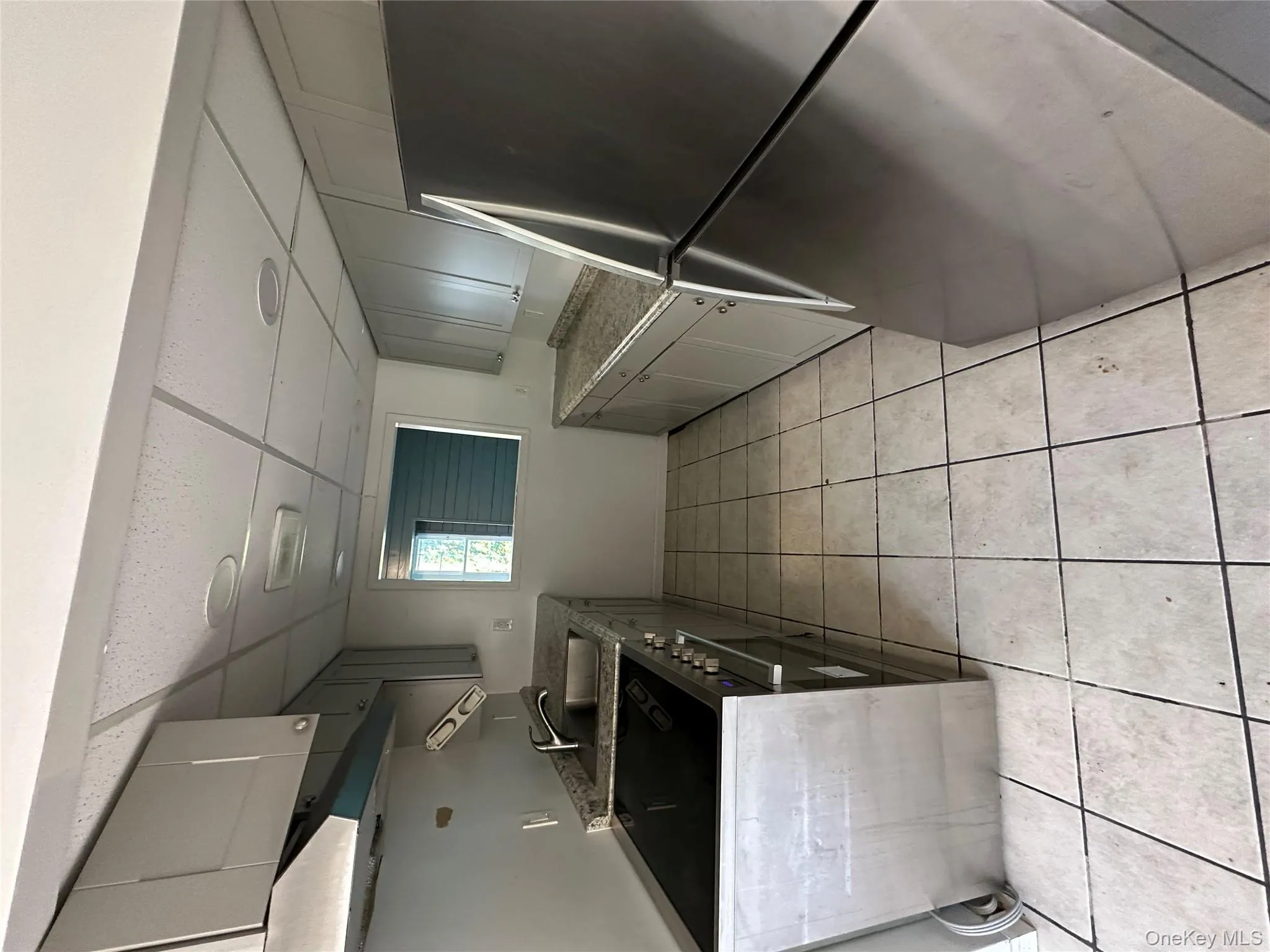 Kitchen featuring fridge, gray cabinets, a paneled ceiling, stove, and ventilation hood Kitchen featuring fridge, gray cabinets, a paneled ceiling, stove, and ventilation hood