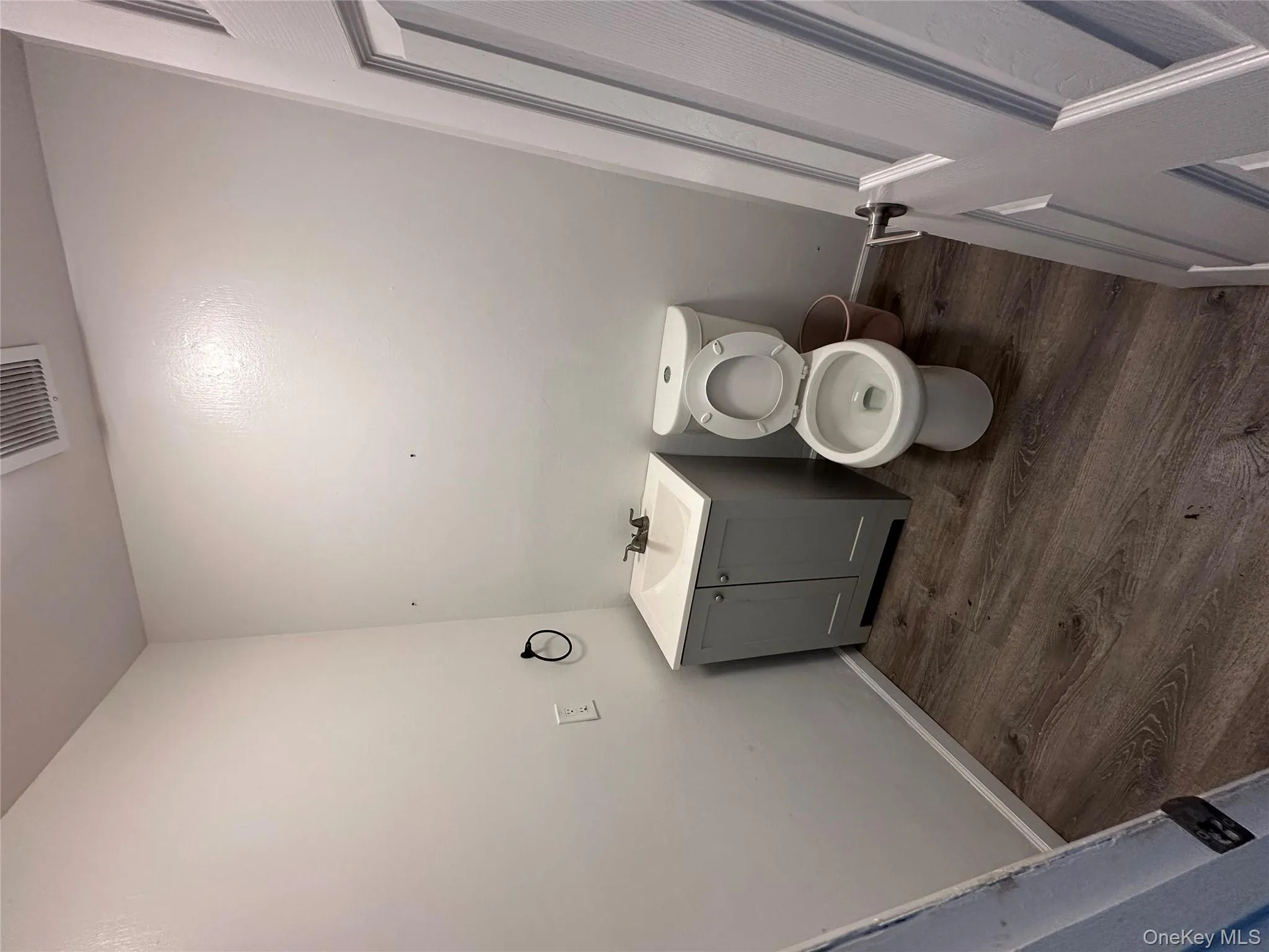 Bathroom with vanity and dark wood-type flooring Bathroom with vanity and dark wood-type flooring