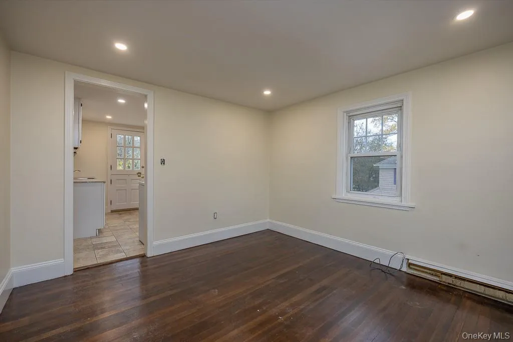 Spare room featuring recessed lighting and dark wood finished floors Spare room featuring recessed lighting and dark wood finished floors