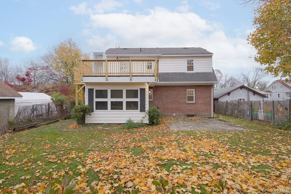 Back of property featuring brick siding, a patio area, a fenced backyard, and a shingled roof Back of property featuring brick siding, a patio area, a fenced backyard, and a shingled roof